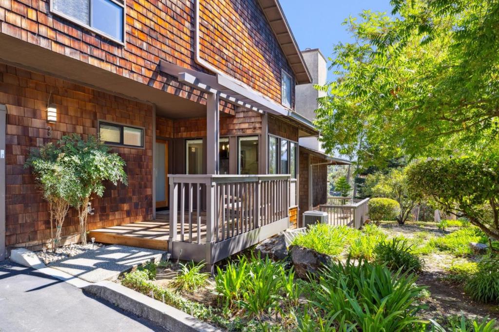 Nestled in the hills above Downtown Menlo Park on a countryside courtyard near Sharon Heights Golf & Country Club is an attached single-family home with a dynamic multi-level layout. From the charming shingled facade to the stunning interior with soaring ceilings, stacked windows, skylights, crisp white walls and contrasting warmth and depth of the Brazilian cherrywood floors, this home is luminous, dramatic and will not disappoint. The layout includes a Euro-style kitchen with dark modern cabinets, Calacatta marble finishes, premium stainless steel appliances and a dining area wrapped in windows, a formal dining balcony with tubular wood handrailing overlooks the spacious living room with its linear fireplace and seamless transition to the backyard deck where serene views can be fully appreciated. Upper levels comprise a bedroom suite with a sunroom and deluxe bathroom with a floating vanity, freestanding tub, step-in shower and walk-in closet, and a delightful loft with barn-style ceiling. This is a home has sophistication AND panache. Sharon Heights is coveted for its peaceful suburban environment and proximity to the Golf & Country Club, Rosewood Hotel, Sand Hill Road VC firms, Stanford everything, Downtown Menlo Park and Las Lomitas schools.