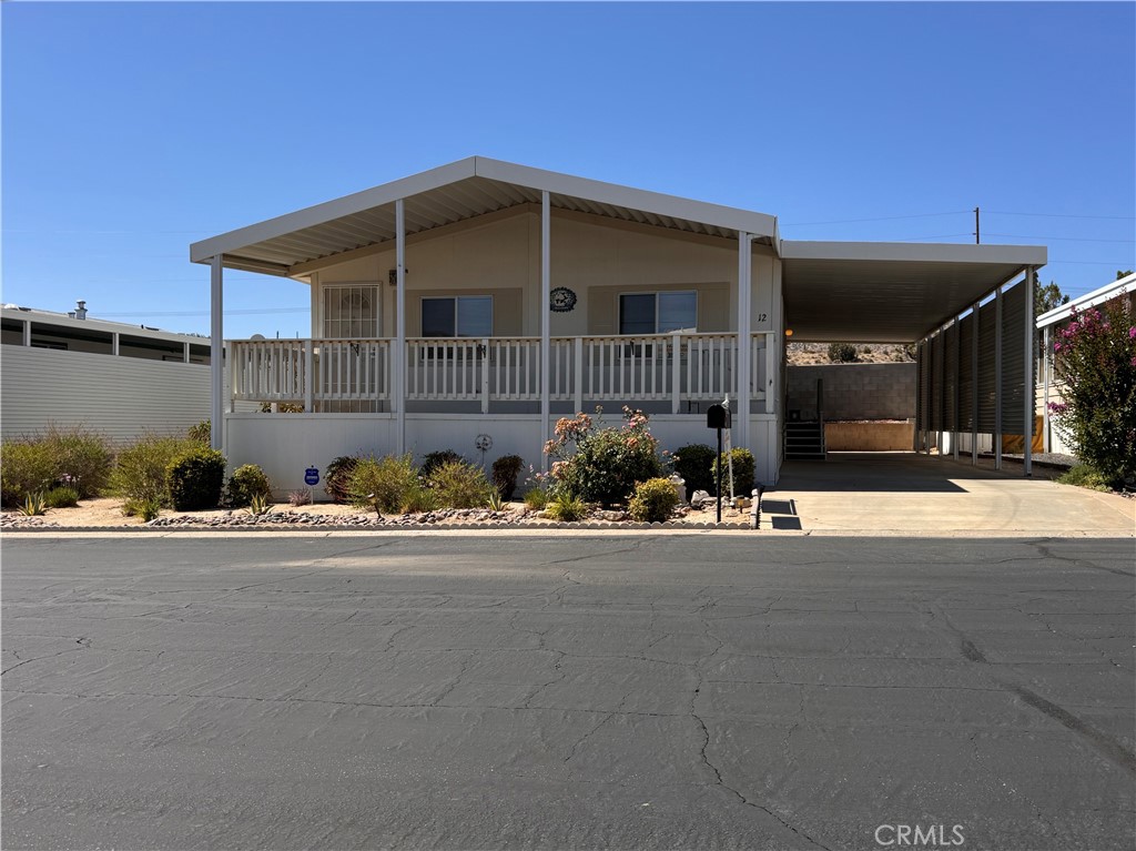 Peaceful 55+ Living with Gorgeous Mountain Views! This newer 2-bedroom, 2-bath manufactured home is located in the desirable Country Club Mobile Estates—a welcoming 55+ community offering quiet charm and resort-style amenities. Enjoy scenic mountain views, a sparkling pool and spa, clubhouse activities, and a friendly atmosphere perfect for relaxing or staying active. Whether it’s stargazing, golf at Hawks Landing Golf Course just across the street, or visiting the nearby Yucca Valley Senior Center, this location has it all. Pet-friendly and full of potential—just update the flooring and move right in! Don’t wait—come see it today! **Owner will consider a flooring allowance**
