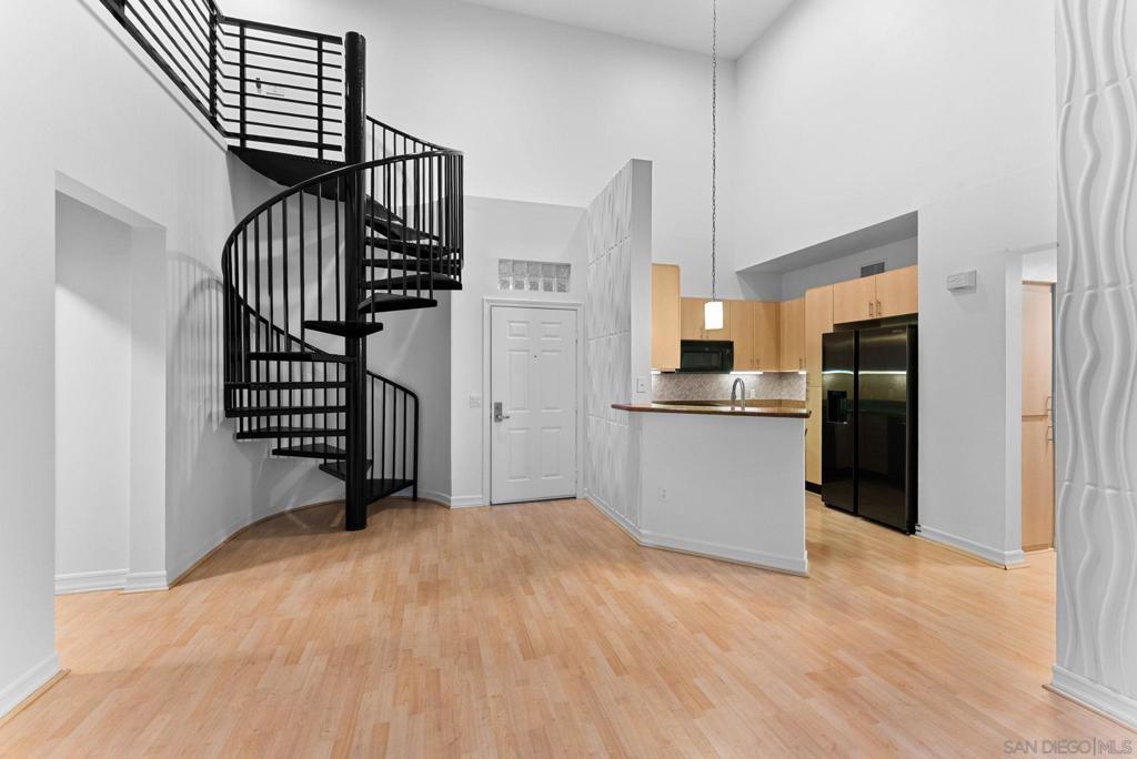 Welcome to this stunning 2-bed Union Square penthouse with a loft, offering stylish living. The bright living room features dramatic 18-foot ceilings, a cozy fireplace, and a private balcony, while a spiral staircase leads to a loft with direct access to a spacious rooftop deck—perfect for entertaining or relaxing.Positioned on the top floor with no neighbors above or on either side, this home offers unmatched privacy. Recent upgrades include brand-new carpet, fresh paint, and updated light fixtures, making it completely move-in ready. Amenities include 2 parking spaces with storage, fitness center, spa, sauna, EV charging station, and more. Located just moments from Balboa Park, Petco Park, Gaslamp, and an endless selection of dining and shopping. With a Transit Score of 79 and easy freeway access, commuting and exploring the city is a breeze.