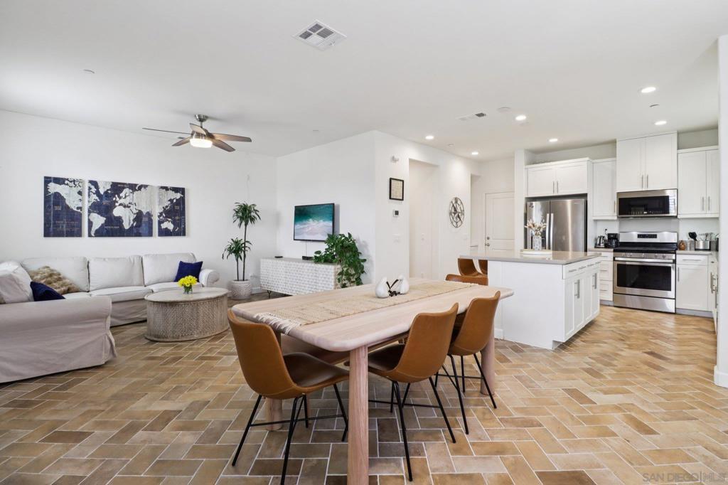 Experience the allure of 511 Surfbird Ln, a modern and inviting home in Imperial Beach’s vibrant Bayside Landing community, where short-term vacation rentals are welcome. This residence boasts a bright, open living area with stylish glazed porcelain tile flooring in a herringbone pattern throughout the first floor. The kitchen, a true centerpiece, features sleek quartz countertops, stainless steel appliances, a large island, and a breakfast bar perfect for morning coffee or casual get-togethers. Upstairs, cozy carpeted bedrooms are linked by engineered white oak hardwood flooring on the stairs and hallways, with the expansive primary suite offering a serene escape, complete with a luxurious bathroom and ample walk-in closet. High ceilings and abundant natural light create a fresh, airy ambiance throughout. The spacious 2-car garage includes a 240V EV charger, providing ample space for vehicles and storage. As part of the VA-approved Bayside Landing, residents enjoy a community pool, relaxing spa, playground, and BBQ grills, ideal for outdoor enjoyment. Steps from the scenic San Diego Bayside Bike Path, stretching from National City to Coronado, this home is perfect for outdoor lovers. With beaches, downtown San Diego, military bases, parks, and local dining just minutes away, 511 Surfbird Ln blends coastal convenience, modern comfort, and the flexibility of short-term vacation rentals.