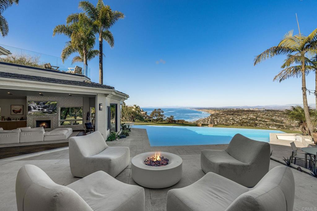 ON TOP OF THE JEWEL! A pinnacle of La Jolla luxury, this William Hayer-designed estate crowns Mount Soledad with breathtaking 180-degree views of the ocean, mountains, and city—while remaining discreetly unassuming from the street. Privately gated on nearly ¾ of an acre, this 8,694 sq ft architectural gem includes over $1M in upgrades. Five ensuite bedrooms with balconies, dramatic two-story foyer, office, home theater, and detached gym with full bath. Award-winning chef’s kitchen with custom white pine cabinetry, top-tier appliances, and seamless indoor-outdoor flow. The reimagined primary suite offers a private balcony, fireplace, spa bath with radiant floors, and custom built-ins. Vanishing-edge dual-level pool, spa, fire pit, outdoor kitchen with built-in heaters, and multiple dining areas. Drought-tolerant landscaping, fruit trees, dry pond, and sport court potential. Tesla EV charger.