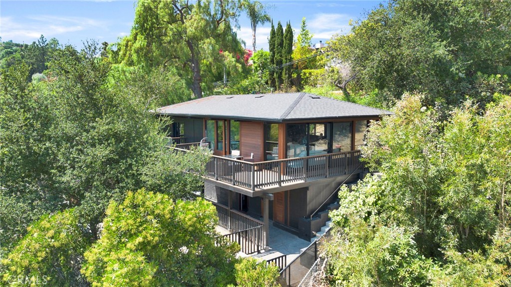 Perched in one of Sherman Oaks’ most coveted south-of-the-boulevard enclaves, this fully remodeled single-family home blends modern luxury with timeless elegance, all framed by sweeping canyon and city views. Every detail has been thoughtfully curated, offering the perfect balance of style, comfort, and functionality. Step inside to a light-filled open floor plan where expansive windows showcase the breathtaking scenery. The spacious living area flows seamlessly into a designer kitchen featuring quartz countertops, custom cabinetry, premium stainless steel appliances, and a generously sized peninsula, ideal for entertaining. Bamboo flooring, recessed lighting, and sleek finishes create an airy, sophisticated ambiance throughout. The primary suite is a true sanctuary with a walk-in closet, en-suite bath and direct access to a private balcony. The secondary bedroom is generously sized and offers flexibility for guests, family, or a dedicated home office. One of the many standout features of this property is the permitted junior ADU, perfect for extended family, a private guest suite, or rental income. Complete with its own entrance, kitchenette, and bath, this space offers unmatched versatility. Outside, enjoy a sprawling deck and patio designed for indoor-outdoor living. Whether it’s morning coffee with sunrise views, an alfresco dinner under the stars, or simply relaxing with the breeze, this home makes the most of its elevated position. Located just minutes from Ventura Boulevard’s dining, shopping, and entertainment, with easy access to freeways and canyon routes to the Westside and Beverly Hills, this exceptional residence offers the best of Sherman Oaks living.