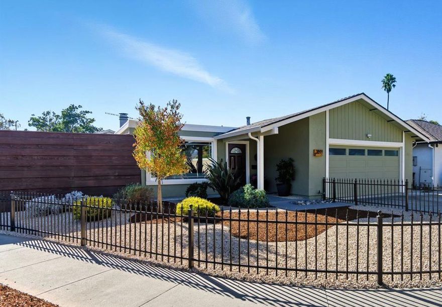 Why settle for a condo or townhouse with HOA fees when you can own a single-family home and enjoy private outdoor space! This 2-bed, 2-bath home offers +/- 1,196 sq. ft. on a +/- 4,929 sq. ft. corner lot, blending convenience, style, and low-maintenance living. The generous sized kitchen with granite counters, roll-out shelves, and freshly painted cabinets flows into the spacious dining area and living room, ideal for everyday living and entertaining. Sliding glass doors off the dining room open to the back patio and off living room leading to the large side yard, help fill the home with natural light. Both bathrooms are remodeled, and the primary suite has its own patio access. The front yard is framed by a wrought iron gate and fence, with new fencing along the front and side yard including a pergola with built-in bench. A large storage shed adds extra space, and the attached two-car garage is wired for 240V EV charging. Recessed lighting, laminate flooring, Nest thermostat and doorbell, drought-tolerant landscaping and freshly painted inside/out, help to enhance this bright, comfortable, low-maintenance home. Centrally located near commute routes and parks, this home combines comfort, convenience, and outdoor enjoyment, a perfect place to call home!