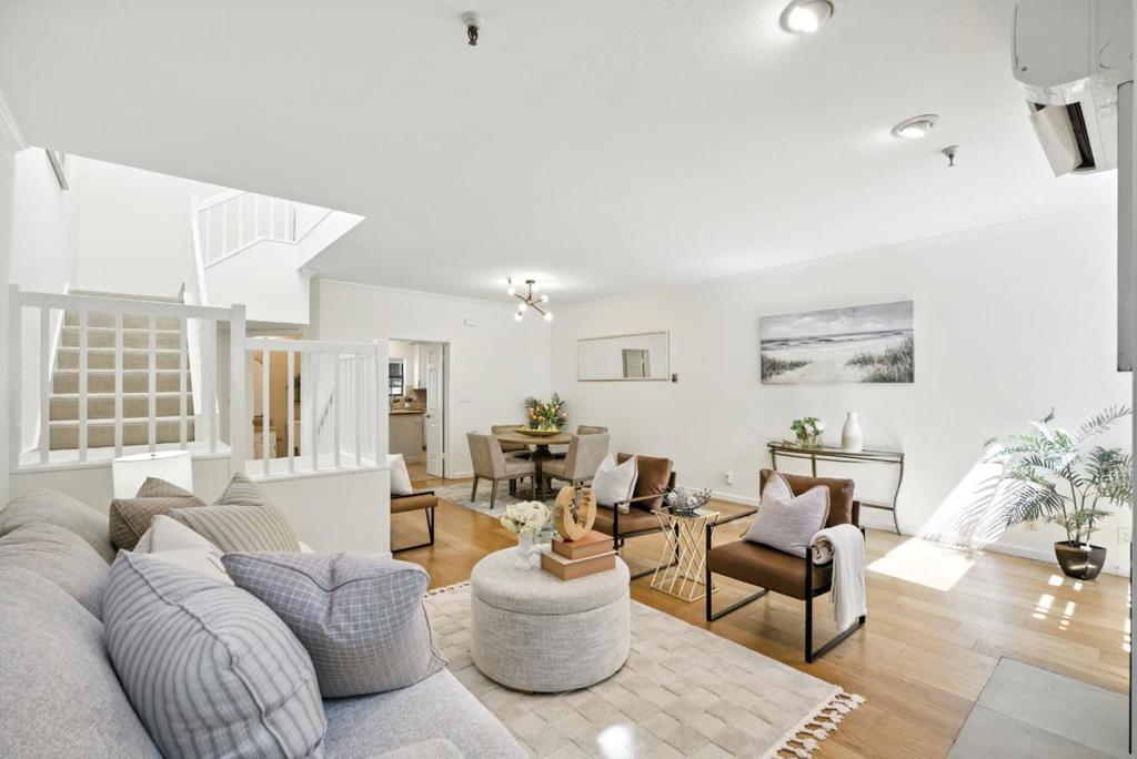 This rarely available home places you steps from everything downtown Palo Alto has to offer, including Whole Foods, parks, American Heritage Museum, renowned restaurants, Stanford University, biking trails, and Caltrain. This beautifully appointed 3-bedroom, 2.5-bath home boasts the best location in the community, featuring a private patio perfect for entertaining or unwinding after a day in town. Inside, you'll find 1,580 square feet of light-filled living space, featuring soaring ceilings, oversized skylights, and two sets of French doors that open onto a serene, landscaped courtyard. The home is thoughtfully designed with custom closet systems, durable flooring, split-unit A/C & heat, and elegant upgrades throughout, quartz countertops in the kitchen and baths, fresh paint, a wine fridge, and a sleek modern fireplace. With top-rated Palo Alto schools, ample guest parking, and a walk-to-everything lifestyle, this turnkey home offers unbeatable value in an unbeatable location.