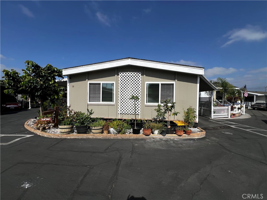 Welcome to Rancho San Jose Mobile Home Park!! 2-bedroom 2 full bathroom home located in an "All Family" mobile home park. Home features an open living room and dining room combo. Spacious den and a sunroom (could be an additional bedroom). Kitchen opens up to the den and the dining room. Tile counters, gas cooktop and dual ovens. Plenty of counter space and cupboards. Separate laundry room with counters and cabinets. Primary bedroom has ample space and large bathroom as well. Storage shed with space for patio furniture. Front porch features "Trex Deck" with plenty of space to sit back and relax. 2-Car covered carport with an electric car charging station. Pool at the clubhouse. Close to schools, shopping and freeways.