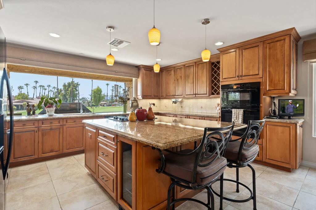 Uniquely MODIFIED/UPGRADED El Grande floor plan at the centrally located Chaparral Country Club. Expanded living room/den with SEE-THROUGH FIREPLACE separating the 2. OPEN KITCHEN with OVERSIZED WINDOW overlooking the 4th green. END UNIT with an EXTRA WIDE SIDE YARD featuring lavish desert landscape and INTERLOCKING PAVERS on the driveway and along the walkway. OWNED SOLAR! Interior features solid core doors, dual pane windows and RAISED CEILINGS & DOORWAYS! Separate laundry room with an extra walk-in closet. 3RD STALL GARAGE with epoxy floors.Kitchen refrigerator just 1 year old. Located on a quiet interior street close to the clubhouse. Community pool and 18-hole putting green right across the street. Club amenities include 18-hole golf course, tennis, pickle ball, fitness center and full-service restaurant.All Buyers to pay $5000 at closing for Capital Reserve Fund. Special Assessment of $100/mo as of 7/1/2025 to Country Club.