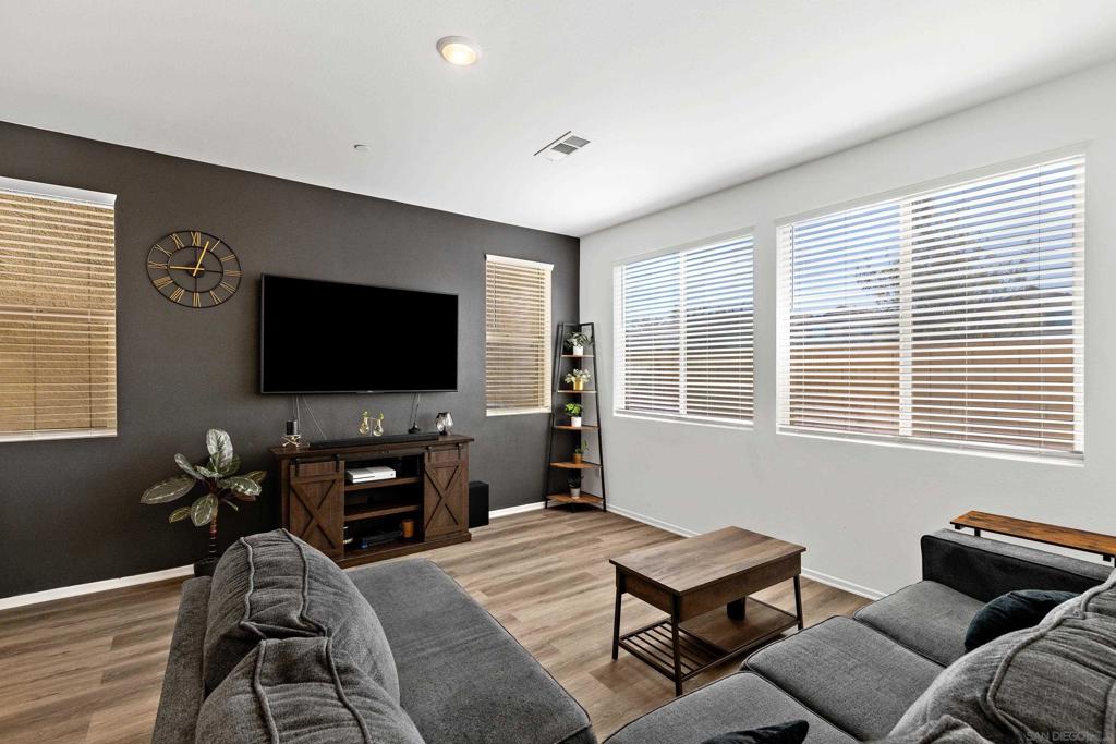 Welcome to 29488 Tourmaline Way — a 2023 build located in the desirable gated community of Outlook at Cooper Skyes, offering one of the largest backyards in the neighborhood and effortless indoor-outdoor living. This beautifully upgraded home features 1,754 sq ft of modern living space with 3 spacious bedrooms, a versatile upstairs loft, and 2.5 bathrooms. Thoughtfully designed and barely lived in, it showcases wide-plank luxury vinyl flooring, an open-concept layout, and natural light throughout, giving every room a bright and welcoming feel. The kitchen, dining, and living areas flow seamlessly to the backyard — a rare oversized lot that’s been fully landscaped with low-maintenance turf, greenery, and hardscaping—perfect for entertaining or simply enjoying the outdoors. Enjoy the energy savings and peace of mind that come with owned solar, plus a short walk to the resort-style community pool for even more relaxation. Located within a secure, pride-of-ownership neighborhood, this 2023-built home offers the feel of new construction without the wait — and all the upgrades already done for you. Tourmaline Way isn’t just move-in ready — it’s lifestyle ready.