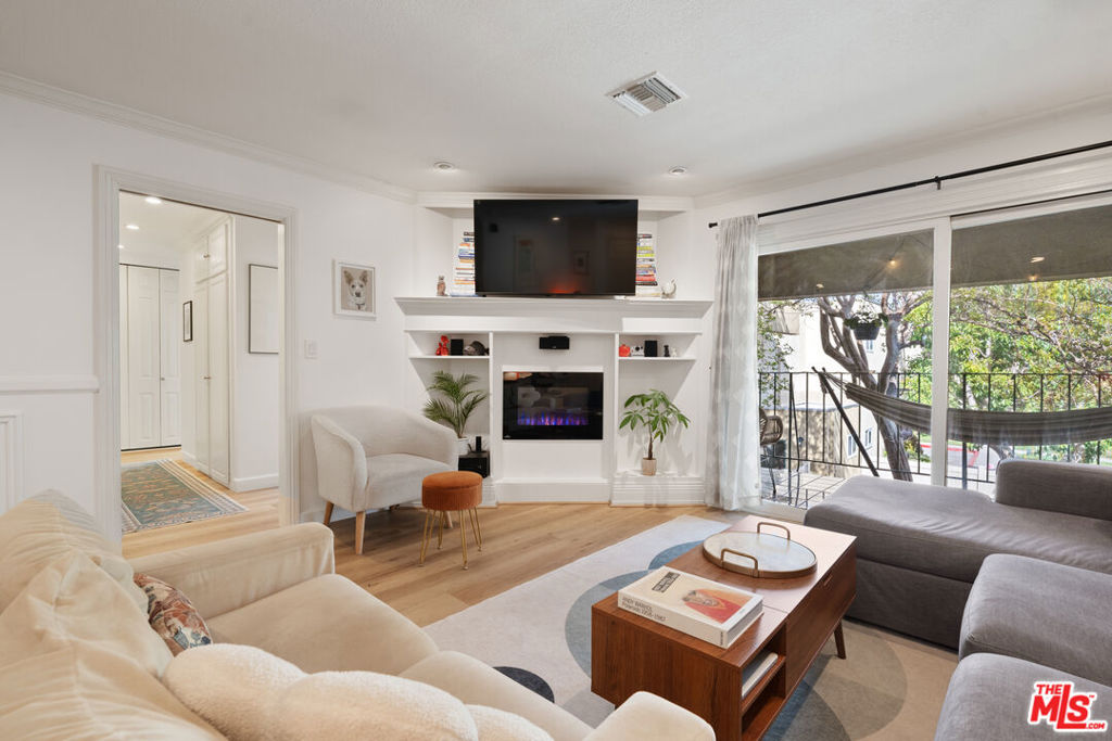 Welcome to Studio City Villas--a gated, Mid-Century garden-style community tucked away in one of the most lush and green corners of Studio City. This beautifully updated, single-story second-floor condo is located at the very back of the complex, offering peace, privacy, and a serene view of the surrounding greenery. Inside, you'll find brand new luxury vinyl flooring throughout the entire unit, in-unit laundry, dual-paned windows, and newer central heat and air. Both bathrooms have just been remodeled with clean, modern finishes, and the stylish kitchen is equipped with high-end appliances and thoughtful details. The spacious front balcony is ideal for al fresco dining, lounging, or enjoying a quiet morning coffee. The layout is open and functional, with well-proportioned rooms and great flow. The primary bedroom includes a generous walk-in closet, and there's no shortage of storage throughout the unit--including a dedicated storage locker in the carport. Other features include a built-in surround sound system and a recently replaced roof. The building is extremely dog-friendly, and the community grounds are lush and beautifully maintained. Resort-style amenities include a large pool, spa, and a grassy dog run just steps from the unit. Tons of guest parking makes it easy for visitors to stop by anytime. HOA dues cover water, landscaping, and earthquake insurance. All of this just moments from Ventura Blvd, Tujunga Village, and the best shopping, dining, and entertainment Studio City has to offer. Don't miss this rare opportunity to live in a quiet, green oasis in the heart of Studio City.
