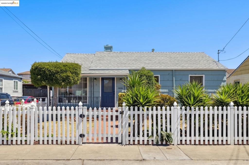 Behind its storybook white picket fence, this Oakland home greets you with a kind of authenticity that’s rare. Three bedrooms, one bath, and a layout that still holds onto its original charm—rooms that feel distinct yet naturally connected. The built-in rotary phone still carries its original 415 number. The baby-blue bathroom? Pure vintage daydream. There’s an ease to the way the spaces work together. Light fills the living room, where a red brick fireplace adds warmth and a subtle focal point. The eat-in kitchen has room to gather and room to breathe. In the back, a spacious, family room shifts with your needs: a quiet wing for reading, a media hub, or the place where friends inevitably gather. Beyond the walls, the lot opens wide. Fruit trees ripen in the sun. Long tables fit easily under the open sky for summer dinners that stretch late into the evening. The detached garage feels destined for something more—an inspired studio, a guest retreat, maybe even an ADU with income potential. The bonus shed is perfect for tools, projects, or storage. Set on a quiet, tightly knit street with BART and freeway access just minutes away, this is a home that blends convenience with character—and invites you to write the next chapter.