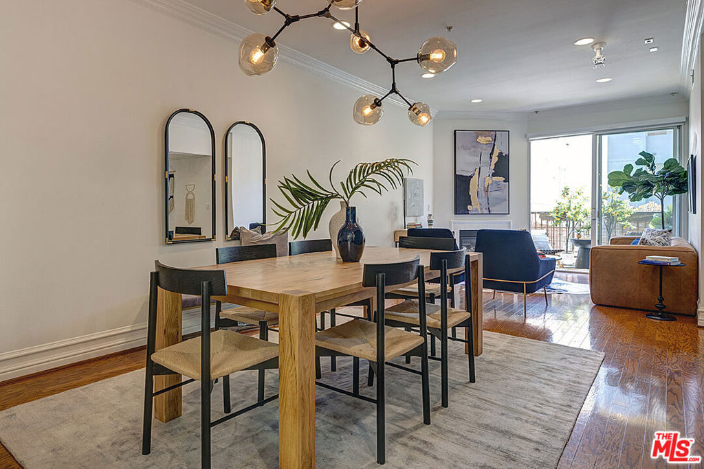 Let Hudson Ave be your next chapter. Welcome to this gorgeous 2-bedroom, 2-bathroom condo located in one of Hollywood's most sought-after neighborhoods. Featuring an open floor plan, this home is perfect for modern living with an generously sized dining area that seamlessly flows into the spacious living area, cozy fireplace and large balcony for morning coffee OR afternoon cocktail/mocktail. The kitchen boasts sleek stainless steel appliances and stone countertops, with handy walk-in pantry offering ample storage space. Both bedrooms are bathed in natural light, with the primary suite featuring oversized windows and a large closet. The primary bath is designed with natural stone accents and includes a dual vanity for added convenience. Additional amenities include central HVAC, a side-by-side washer and dryer in unit, and separate storage space in the garage. Hardwood floors in the main living area add warmth and charm, and two parking spaces are included in the gated garage, which also offers ample guest parking. Residents enjoy access to a community gym, and the location is unbeatable -- just moments from the vibrant Sycamore District (Sightglass, Tartine, Supervinyl, art galleries, etc) Gold's Gym, Heimat gym, and several major studios. You're also in close proximity to Hancock Park, Larchmont Village, and all the best that Los Angeles has to offer. Hudson Ave - the heart of Hollywood Living.