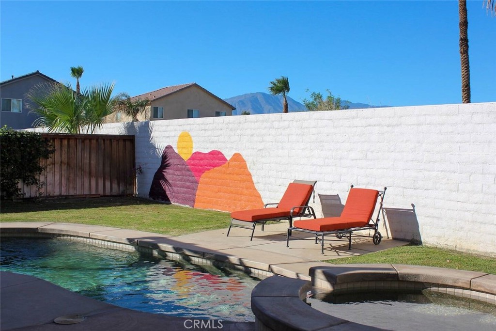 Immaculate and fully furnished Spanish-style retreat in the highly sought-after La Colonia community. This 4-bedroom, 3.5-bath home includes an attached casita with a private entrance and bath—ideal for guests or multi-generational living. Inside, soaring high ceilings and an open floor plan connect the formal dining area, spacious living room, and a chef-inspired kitchen with granite countertops, gas range, built-in appliances, and a brand-new refrigerator. Comfort is enhanced with a brand-new AC system for the main house and a new mini-split unit in the casita. Outdoors, your private backyard oasis awaits with a heated pebble-finish pool and spa, covered patio, and lush landscaping—perfect for relaxing or entertaining. Additional highlights include a 2-car garage, laundry room, ample parking, no HOA, and short-term rental approval. Prime location just minutes from shopping, dining, golf courses, and world-famous festival grounds.