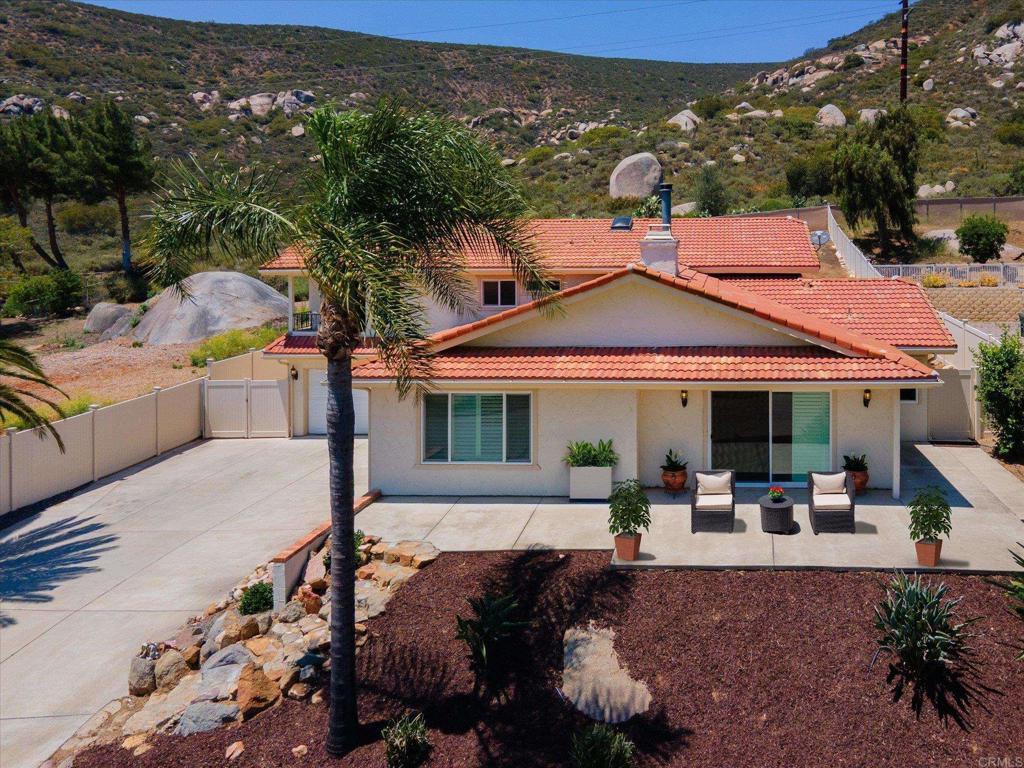 **Motivated Seller – Bring Your Creative Offers!** Located in San Diego Country Estates, this move-in ready 4-bedroom, 2.5-bath split-level home offers 3,039 sq. ft. of updated living space. Highlights include vaulted ceilings, plantation shutters, and a dual-sided fireplace connecting the living and family rooms. The kitchen and bathrooms have been tastefully updated, and the upstairs laundry adds convenience. A spacious flex room with built-in bar provides endless options—perfect as a home office, gym, playroom, or multigenerational suite. The well-designed primary retreat features a sitting area, private balcony, soaking tub, walk-in closet, and abundant natural light. Additional upgrades include a 3-car garage with epoxy flooring and 220V outlet for EV charging. The low-maintenance yard offers turf, vinyl fencing, a covered patio, and a pergola-ready pad with space for a jacuzzi. A Tuff shed adds storage, and mountain views can be enjoyed from multiple vantage points. Families will appreciate proximity to award-winning Barnett Elementary. Residents of San Diego Country Estates enjoy resort-style amenities including a golf course, equestrian center, tennis and pickleball courts, pools, parks, hiking trails, and a recreation center.