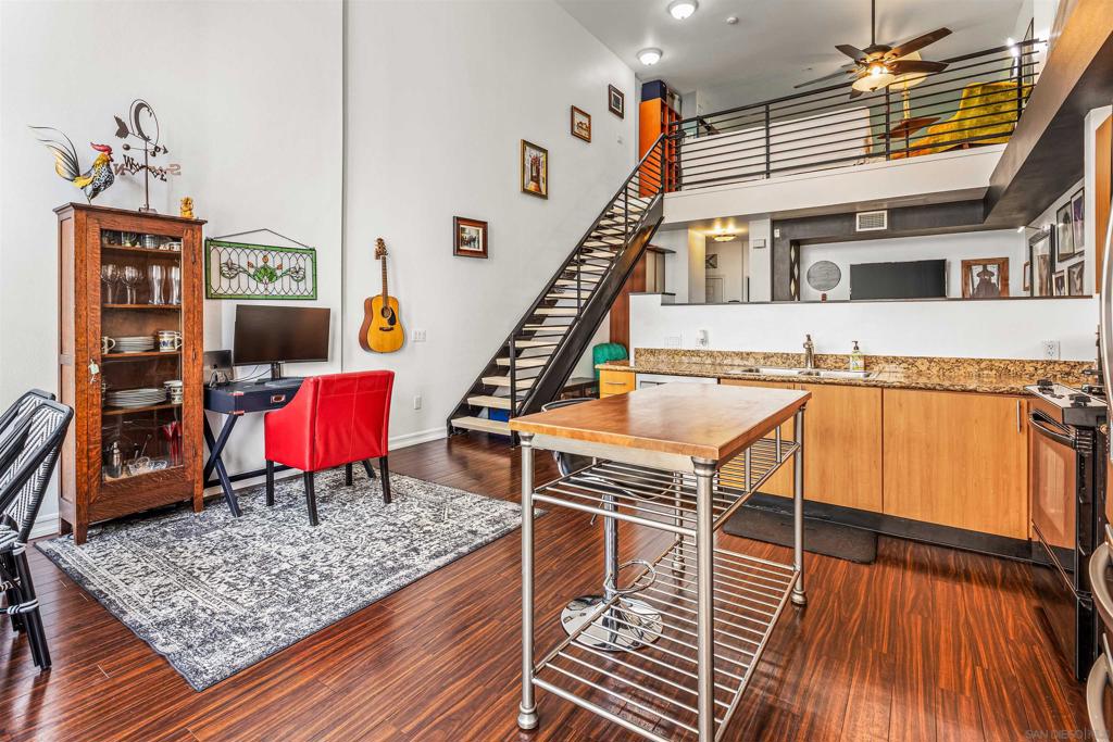 Fall in love with this charming top-floor loft in the heart of East Village, offering exceptional value and style. Soaring 18-foot ceilings and a bright, airy layout create an inviting atmosphere, while gorgeous upgrades are found throughout. The open, updated kitchen with sleek finishes flows seamlessly to the dining area and living room, making it perfect for both everyday living and entertaining. A private balcony provides the perfect place for your morning coffee, sunny afternoons or evenings in the idyllic San Diego weather. The residence also features a versatile 1+ bedroom layout, offering a private loft bedroom as well as bonus space for a quaint living room, home office or guest area. A custom built window seat with storage adds a quaint place to relax and unique storage space. In-Unit laundry includes a full-size stacked washer and dryer. One assigned parking space in the underground parking garage makes parking effortless. You will find little need to drive being conveniently located just down the street from Petco Park, the Gaslamp Quarter, shopping, dining, entertainment, but also quick freeway access, Union Square is VA approved and delivers resort-style amenities including a fitness center, spa, sauna, recreation room with pool table, and more. Offering an unbeatable combination of location, layout, and lifestyle amenities, this one-of-a-kind condo brings together everything you want in urban living—and more. This is urban living at its finest.