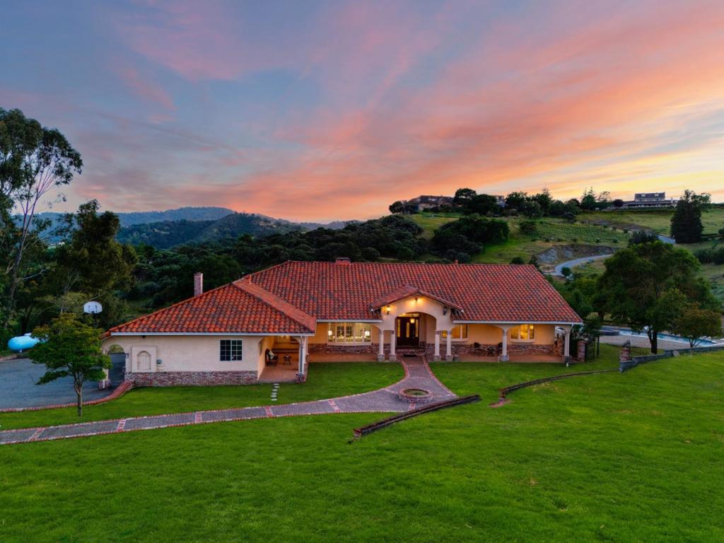 Nestled in the picturesque landscapes of Morgan Hill, this Castle Hill estate offers a perfect blend of spaciousness, comfort, and contemporary elegance. Boasting 3986 SF of meticulously designed living space, this residence is an epitome of luxury living. Stepping inside, you are greeted by an inviting foyer that seamlessly flows into the expansive living areas with high ceilings & abundant natural light cascading through large windows. The open-concept layout connects the living room, dining area, and gourmet kitchen, creating an ideal space for entertaining. The gourmet kitchen is a chef's dream, featuring stainless steel Viking appliances, granite countertops, a center island, and ample storage space in custom cabinetry. Retreat to the luxurious master suite, complete with a spacious bedroom, a spa-like en-suite bathroom with dual vanities, a soaking tub, and a separate shower, this master retreat offers the ultimate in relaxation and rejuvenation. 3 additional bedrooms provide ample space for family members or guests, each offering comfort and privacy. Outside, the expansive backyard is an entertainer's paradiseConveniently located in the desirable city of Morgan Hill, residents will enjoy easy access to local amenities, parks, shopping centers, and top-rated schools.