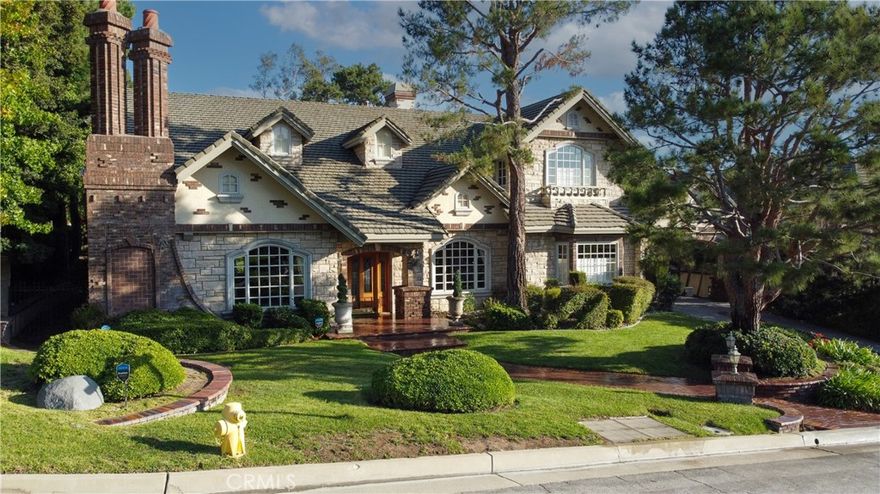 Step into a masterpiece of design and craftsmanship, custom-built in 1990 by an award-winning builder, nestled on a prestigious corner lot in Morgan Ranch. This 4,883 sq ft home features a luxurious primary suite with fireplace, spa tub, walk-in shower, and dual walk-in closets. Rich finishes throughout include marble floors, crown molding, and custom cabinetry. Multiple living spaces include a paneled great room with massive brick fireplace and full bar, formal living and dining rooms, library, and upstairs loft. The chef’s kitchen boasts Viking appliances, custom detailing, and a walk-in pantry. A ground-floor bedroom suite offers flexibility for guests or multi-generational living.Outdoor living is a private retreat with a custom pool, sunroom, built-in BBQ, and spacious yard. A porte-cochère, long driveway, and detached 3-car garage complete this exceptional estate in one of the area’s most desirable neighborhoods.