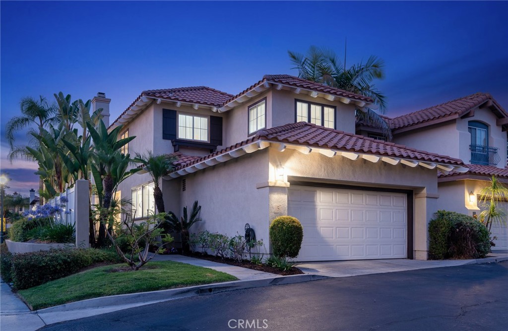 Welcome to 5 Via Floria, a beautifully upgraded 3-bedroom home with a spacious loft and 2.5 baths, located in the desirable Villavante Tract. From the moment you arrive, you’ll be greeted by a beautifully landscaped entry that sets the tone for the inviting interior. The kitchen features granite countertops, white cabinetry, travertine floors, recessed lighting, a cozy breakfast nook, and brand-new stainless-steel appliances including an oven, microwave, and dishwasher. The living room is warm and welcoming with a fireplace accented by a classic white mantle, travertine floors and plantation shutters, while the dining area, with its mirrored wall, opens seamlessly to the living space, ideal for entertaining. A striking staircase with elegant wrought-iron railing leads you upstairs to a versatile loft and the bedrooms with new carpet. The primary bedroom is a relaxing retreat, complete with mirrored closet doors and natural light. The ensuite bathroom has been thoughtfully upgraded with dual vanities topped with granite countertops, white cabinetry, a stone stall shower, a granite tub surround, and a walk-in closet. Down the hall, you’ll find two additional bedrooms with mirrored closet doors and a full guest bathroom with white cabinetry. Additional highlights include a convenient downstairs laundry room, an upgraded powder room with granite counters, and a two-car attached garage. The backyard is beautifully landscaped with hardscape, perfect for outdoor entertaining or simply enjoying the California sunshine. Residents of Villavante enjoy a community pool and all the Rancho Santa Margarita incredible amenities, including the Beach Club Lagoon, multiple pools, tennis courts, scenic hiking trails, parks, an amphitheater with summer concerts, the lake, and so much more!