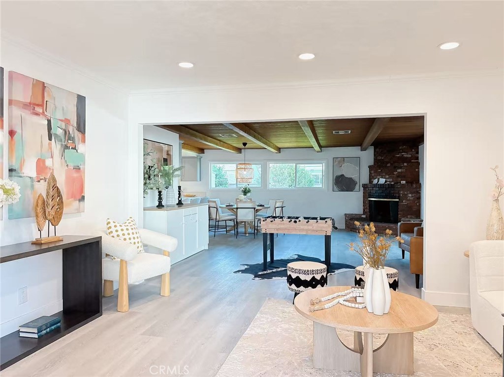 Welcome to 315 E Oakmont Ave, a beautifully maintained single-family residence located in a quiet and desirable neighborhood of Orange. Step inside to an open-concept living area filled with natural light, featuring sleek hardwood floors, a contemporary fireplace, and seamless flow into a state-of-the-art kitchen. The gourmet kitchen dazzles with quartz countertops, custom cabinetry, a large center island, and top-of-the-line stainless steel appliances, perfect for culinary enthusiasts. The adjacent dining area opens to a beautifully landscaped backyard, ideal for entertaining or relaxing in the California sunshine. The primary suite is a tranquil retreat with a walk-in closet and a spa-inspired ensuite bathroom, complete with a double vanity, soaking tub, and glass-enclosed shower. Two additional bedrooms offer ample space and modern finishes, perfect for family, guests, or a home office. The second bathroom has been elegantly updated with designer tiles and fixtures. Additional upgrades include energy-efficient windows, smart home technology, central A/C and heating, and two-car garage with extra storage. Located just minutes from Old Towne Orange, top-rated schools, and major freeways, this move-in-ready home blends timeless charm with modern luxury, offering the perfect opportunity for comfortable and stylish living in a vibrant community.