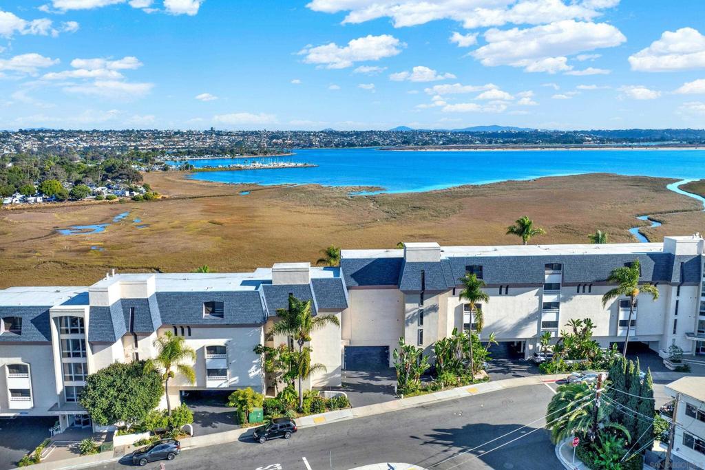 Breathtaking views of Mission Bay, Sea World, Fiesta Island and Downtown. Nestled above the Kendall Frost Mission Bay Marsh Reserve, this home offers the perfect blend of serene natural beauty and easy access to the vibrant coastal lifestyle. Enjoy poolside BBQ's, convenient on-site laundry facilities, and a deed conveyed covered parking space. Step inside to discover a freshly remodeled bathroom with walk in shower, brand new flooring that makes this unit truly shine. Easy access to walking-running and bike paths around the bay. This is San Diego Living at it's finest. Priced to sell.