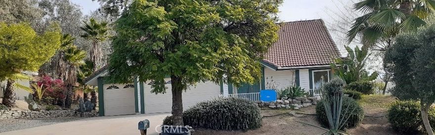 This single-story Solar Powered Home is located in the” Victorian Estates Community”. It’s situated on a .46-acre lot in one of the most desirable neighborhoods of Wildomar.  NO HOA and LOW PROPERTY TAX
3-bedroom 2-bath, 1812 sq ft home is the perfect combination of functionality, and charm. Enjoy the open floor plan, high beam ceilings, spacious living and dining room, Pot shelfs throughout the home to show off your pretty collectable. 
Designer ceiling fans and light fixtures, professionally laid tile floors and whole interior has been freshly painted. Lots of natural light in kitchen with huge windows, newer custom hickory cabinets, large breakfast bar, colorful pendent lights and a cozy bonus room with brick fireplace which leads out to the patio and swimming pool.
Backyard has a variety of mature trees and flowers for a park like setting, custom tile patio with a gazebo and lots of steppingstones leading to the pool and different areas of the yard. Completely fenced with gate entrance for possible RV parking and four sheds for storage.
New carpet in all three bedrooms.  The master has 2 large closets and patio glass doors leading out to the pool. The spacious attached bathroom has custom tile designs in this large walk in shower and a colorful slate floor.  Three car garage has lots of room for storage in the high ceiling rafters and washer and dryer hookups. 
Minutes to the 15 Freeway, with quick access to shopping, schools, hospitals, restaurants and the famous Lake Elsinore which is the largest freshwater lake in Southern CA, with boating, fishing, and water sports.