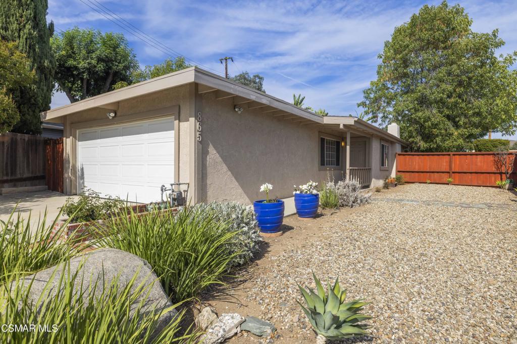 Welcome Home to this lovely single story home in the heart of Thousand Oaks. Featuring 3 bedrooms and 2 Baths, this 1200 square foot home is light and bright with a wood beamed ceiling in the living and dining room and a lovely hearth fireplace with brick surround and wood mantle. The Dining room is open to the Living Room and Kitchen as well as the backyard garden area. Enjoy new hard surface wood-like flooring in the foyer, living room, bedrooms, hallway and closets. The dining, kitchen, laundry room and baths have lovely tile flooring. The laundry room is an interior room adjacent to the kitchen. Outside is a very spacious front yard featuring a finished two car garage, extra paved driveway area for plenty of parking and an additional area with a private shed. There is a spacious wood privacy wall in the front yard creating an additional outdoor space for entertaining and welcoming guests. Washer, dryer and refrigerator are included. Enjoy Central AC and much more. Check back for video tour.