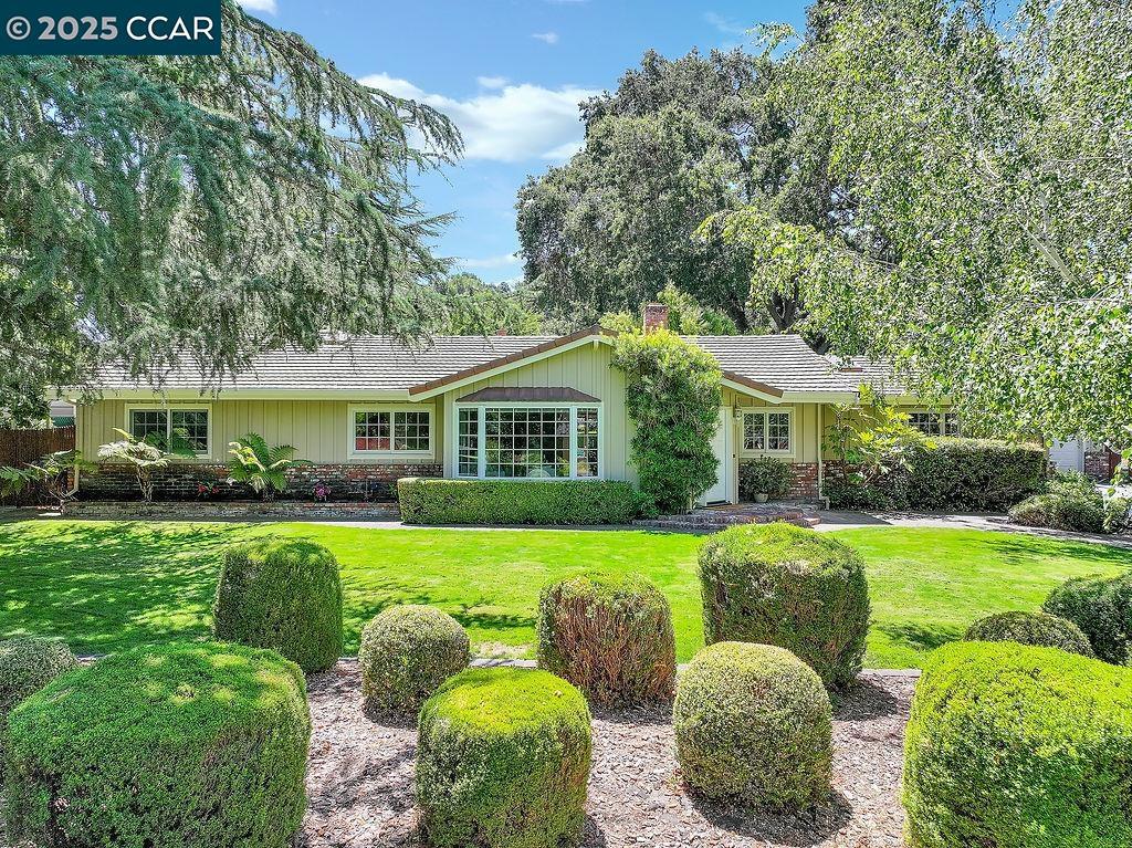Spacious single-story home in serene Alhambra Valley, set on over half an acre of lush, park-like grounds. This 4-bed, 2-bath home features a large updated kitchen with granite counters, stainless steel appliances, breakfast nook, and butler’s pantry. The oversized family room boasts wood beam ceilings, a striking stone fireplace, and natural light pouring in from doors leading to the backyard. The primary suite includes two walk-in closets, vaulted wood beam ceilings, and a spa-like bath with dual sinks, soaking tub, shower, and water closet. Hall bath also offers dual sinks and separate tub and shower. A spacious laundry room and abundant storage complete the interior. The expansive yard features a sparkling pool, greenhouse, chicken coop, storage shed, and space for a sport court or more. Massive 3-car drive-through garage with shop area and full bathroom. Ample driveway and RV parking. A private, peaceful retreat with room to live, entertain, and grow. This rare property combines space, function, and lifestyle in one of the most scenic areas in the East Bay. Close proximity to Napa Valley and SF. Open Sunday, 8/24, 1:30-4