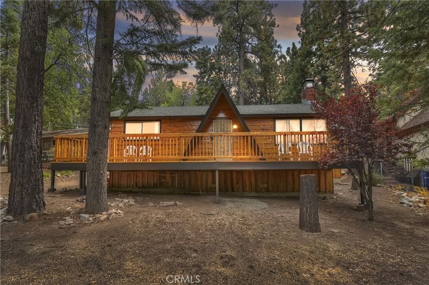 EASY IN & OUT STREET-TO-STREET LOCATION IN MOONRIDGE! Discover this charming single-story home nestled in a beautiful wooded setting. Featuring two bedrooms and one full bathroom, this property boasts a woodsy interior, a spacious laundry/mud room, vaulted open-beam ceilings, a used brick fireplace, and a cedar slab breakfast bar. The extensive decking and the cedar siding have been refurbished, looking as good as new. Situated on a large, heavily treed 9,300-square-foot lot, this home offers easy year-round accessibility. It has great potential to add an ADU or garage, and the interior is like a blank canvas, allowing you to make it your own.