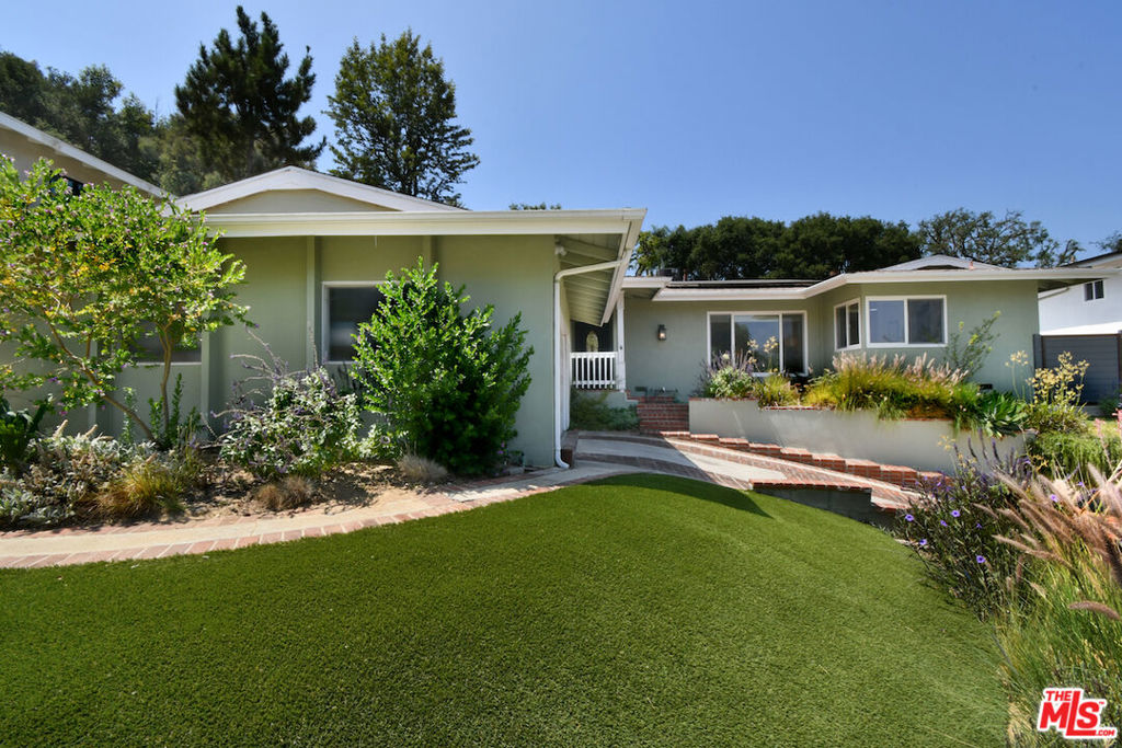 A family haven at the end of a peaceful cul-de-sac in the bucolic hills of Sherman Oaks, this inviting single-story home offers a rare sense of calm and privacy. Just moments from Sepulveda Pass, Mulholland, and Ventura Boulevard, the location makes it easy to get anywhere yet the setting feels like a world apart, a safe and welcoming place to call home. Appreciate the large lot sit which affords maximum privacy. Children can ride bikes or play ball in the flat cul-de-sac, while the backyard is perfect for outdoor games, summer barbecues, or evenings gathered around under the stars. Inside, the home is filled with warmth and light. The formal living room looks out to the yard, the dining room is ready for family meals and holiday gatherings, and the spacious kitchen with its sunny breakfast nook is the heart of daily life where mornings begin and conversations linger. An en suite bedroom near the entry makes an ideal guest suite or a productive home office with beautiful natural light. On the other side of the home, two secondary bedrooms share a bathroom and sit next to the primary suite, an easy and thoughtful layout for young families. The large flat grassy yard has ample room for a stunning swimming pool. Excellent space for an organic garden. The paved basketball court also enables kids to safely stay at home to exercise and play. Relax in the oversized hot tub, or entertain outdoors watching the ballgame, BBQ-ing, and al fresco dining. Here, every space feels comfortable, practical, and full of heart. It's a place to grow, to laugh, and to create lasting memories in a bucolic setting that's both private and connected.