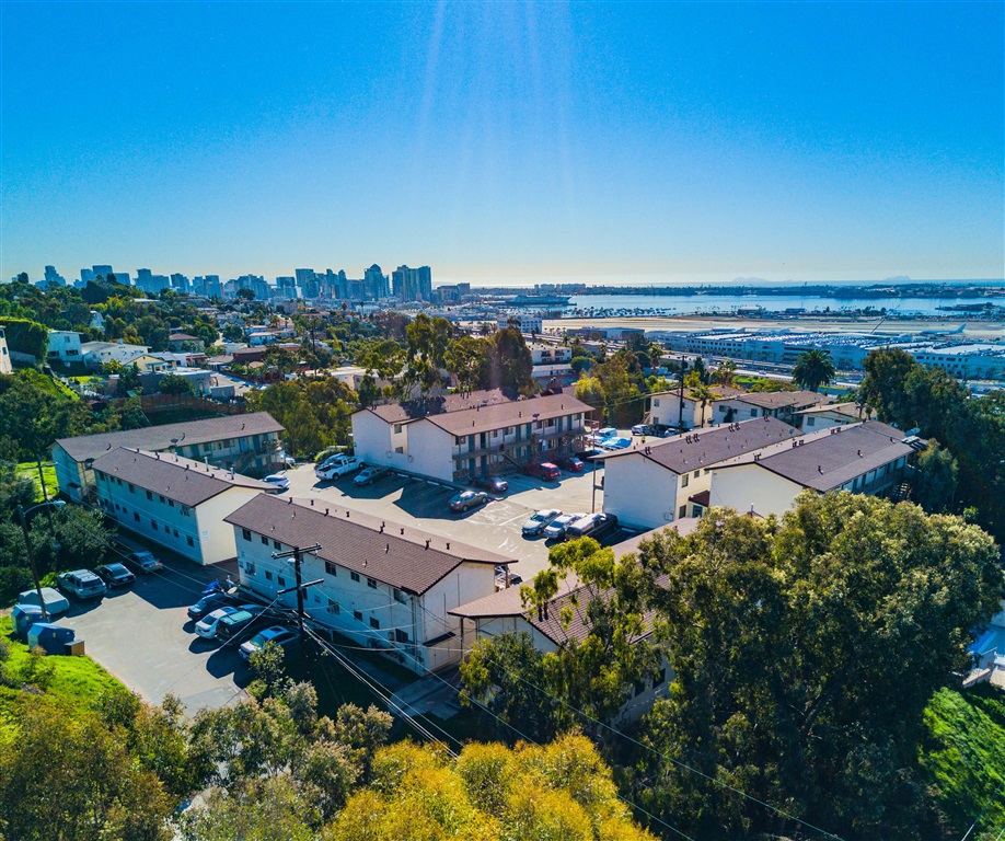 The Royal Apartments consist of 121 units housed in 12 structures built with wood frame construction in the early 1960s and situated on two parcels totaling approximately 79,699 sq ft of land in an irreplaceable location in Mission Hills with views of the San Diego Bay, Coronado, Harbor Island, and Point Loma. The property features 120 parking spaces, a pool and BBQ deck area, and 2 laundry facilities. 104 of the units are 320 sq ft studios, 16 units are 365 sq ft studio units with an additional alcove, and there is one 612 sq ft cottage by the pool with canyon views. There is a balcony linking two of the westernmost buildings that offers 180 degree views as well as additional common patio space. This property has not yet experienced the extensive upgrading typical of other apartments in San Diego’s prime urban neighborhoods including Mission Hills. The units feature a mix of faux wood, vinyl plank, and carpeted flooring. Some bathrooms have been remodeled with shower/tub enclosures and Espresso vanities.