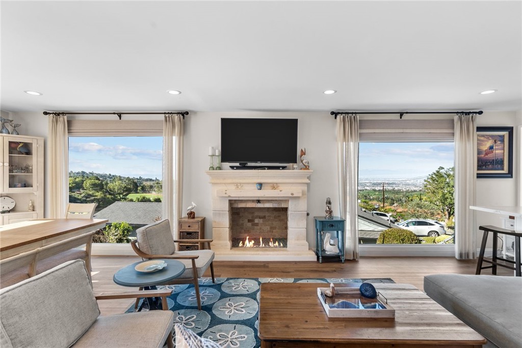Stunning Mediterranean style one level home on one of Westfield’s most beloved streets. This Palos Verdes Peninsula home offers expansive views of the South Bay, city lights, and mountains. The layout includes three bedrooms and two bathrooms on the main level, with a few steps leading to the spacious living room—creating a mostly single-level floor plan. Spectacular stone work, Thermador appliances, artistic custom iron work and a host of designer finishes that combine to create that feel of resort style living. The kitchen features white cabinetry, white quartz countertops, stainless steel appliances, and a large window that brings in natural light and views of the surrounding greenery. It’s a functional and inviting space for cooking and gathering.
Primary bathroom has dual stone vessel sinks on a granite countertop, a walk-in shower and a separate soaking tub. The second bathroom features a walk-in shower with travertine and quarts style finishes and updated fixtures.
The outdoor area includes a pool and above ground spa, complemented by a covered patio with classic columns and exposed wood beams. Whether enjoying quiet moments or hosting, the space offers flexibility and comfort.
An additional approximate 300 square foot bonus room on the lower level with a separate entrance offers additional space and potential for a variety of uses. This space is not included in the original square footage. With enduring style and outdoor amenities, this property offers a rare opportunity for relaxing or entertaining in your own stay-cation backyard resort with panoramic scenic location.