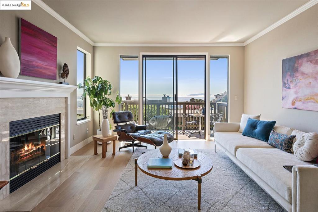 31 Spyglass is a rare stand-alone townhouse offering a thoughtfully designed living space and sweeping views of the Bay, downtown Oakland, and the SF skyline, as well as the Bay and Golden Gate Bridges, which truly elevate the everyday. You’ll love the interior-access garage with extra storage and a bonus space with a window — perfect for a home office, gym, or creative studio. A gated front porch sets an inviting and private tone, and the oversized front door opens to soaring vaulted ceilings accented by a Nelson Cigar Bubble Pendant and skylight. The living room with fireplace leads to a private balcony where the panoramic views take center stage — it feels like you could reach out and touch the Bay Bridge on-ramp. The updated kitchen features freshly painted cabinetry paired with stone counters in a calming, monochromatic palette. From the kitchen sink, you can enjoy direct views of the Bay and Bridges and the SF skyline — even washing dishes is a moment. In the dining room, a folding glass door opens to an ultra-private patio, perfect for indoor-outdoor flow. Every bedroom features gorgeous views — from the Bay to the Bridges, and the glittering SF skyline beyond. Enjoy the close proximity to Peets, Fournee Bakery, and Rockridge. And the views, they never get old! Views: Downtown