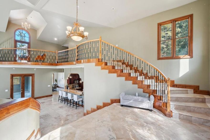 Back on the Market! Seller's loss Buyer's gain. Excellent location! This Residence features 8,025 sf, over 7 acre including a second lot w/ 5 bedrooms, 5 1/2 bathrooms, 3 bedrooms each boasting a private bath plus an expansive master suite w/ a private balcony w/ breathtaking views. Modern gourmet kitchen seamlessly connected to a covered patio ideal for al fresco dining and entertaining. Grand living room impresses w/ tall windows & ceilings, a cozy fireplace, integrated wet bar, adjoining covered deck/balcony invites you to savor the picturesque surroundings. Separate formal dining room, & 2 distinct family rooms offer versatile spaces for both quiet relaxation and lively gatherings. Additional features include a home theater for the ultimate cinematic experience, an exercise room to support your active lifestyle, & a convenient laundry room. Open floor plan, accentuated by high ceilings and natural light, creates a fluid indoor-outdoor living environment that complements the home's upscale character.