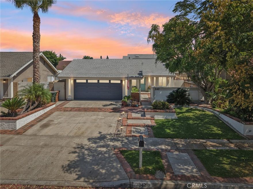 Welcome to 242 N Camino Arroyo, a stunningly updated home in Anaheim that blends modern design with comfortable living. This 4-bedroom, 2-bath residence is thoughtfully designed with an open-concept floor plan, abundant natural light, and stylish finishes throughout. Inside, you’ll find a spacious living area anchored by a cozy fireplace and illuminated by skylights that brighten both the kitchen and living room. The beautifully remodeled kitchen features sleek white cabinetry, high-end stainless-steel appliances, and plenty of counter space to inspire your inner chef. The dining area flows seamlessly into the main living spaces, creating a warm and inviting atmosphere. The private master suite is a true retreat, offering a massive walk-in closet and a spa-like bathroom with dual sinks and modern finishes. Upstairs, a versatile loft area leads to the fourth bedroom and its own closet, along with a balcony that captures a pleasant view—ideal for morning coffee or evening relaxation. Behind a closet wall, you’ll also discover a capped and closed-off additional bathroom, ready to be completed and transformed into extra functionality. The upgrades continue with a fully insulated garage featuring epoxy floors, making it as practical as it is polished. Electrical updates throughout the home provide modern efficiency and peace of mind. Additional highlights include updated flooring, recessed lighting, and a functional layout that balances modern upgrades with everyday comfort. Outdoors, the home offers a large front yard, spacious driveway, and attached garage, while the backyard provides a peaceful retreat with grassy and paved areas—perfect for gatherings, play, or simply unwinding in the fresh air. With its prime location in Anaheim, close to parks, schools, shopping, and dining, this home offers the perfect blend of style, space, and convenience. Don’t miss the chance to make this turnkey property your new home!