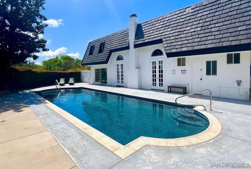 Discover a picturesque haven in Escondido with this luxurious countryside estate, nestled in the rolling hills of North County. Offering a perfect blend of opulence and tranquility, this expansive 21-acre property is surrounded by flourishing avocado and citrus groves, creating a serene retreat. The main residence boasts over 5,000 square feet of living space, featuring 5 bedrooms, 3 full bathrooms, and 3 half bathrooms, including master suites on both levels and a convenient downstairs guest bedroom. Fully remodeled in 2022, the home exudes luxury with a grand foyer, a spiral staircase, and elegant finishes throughout. Entertainment is effortless with a dedicated home theater and a stunning, private below-ground pool, perfect for relaxation. Additionally, a newly remodeled detached ADU, completed in 2024, offers over 800 square feet with 2 bedrooms, 2 bathrooms, central air conditioning, and an attached patio deck with breathtaking mountain views. The estate’s natural beauty is further enhanced by an onsite pond, native trees, and a concrete pad ideal for a pickleball court. With ample parking for over 50 cars, this property is perfect for hosting large gatherings or even wedding events. Beyond its residential appeal, this estate is a proven income-generating asset, grossing $100,000 plus on Airbnb short term rentals, with even more potential through the rental of the ADU. Whether seeking a luxurious private retreat or a profitable investment opportunity, this exceptional property offers the best of both worlds.