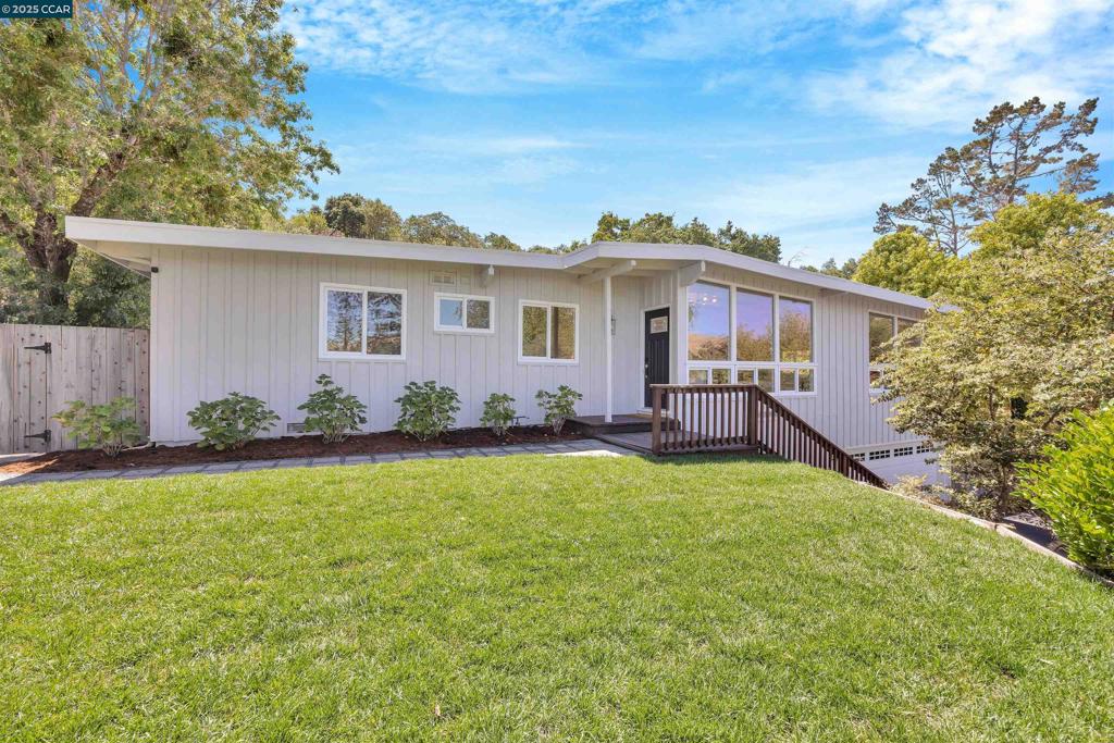 Tucked back from the road in the charming Lafayette Valley Estates neighborhood, this updated mid-century modern gem blends timeless style with everyday convenience. Just steps from the beloved Lafayette walking and biking trail and minutes to top-rated Burton Valley Elementary, the community center, and local swim clubs, the location makes daily living a breeze. Thoughtfully refreshed throughout, you’ll find four bedrooms and two bathrooms. Airy open-concept kitchen and family room framed by walls of windows that fill the space with natural light. The updated kitchen features new countertops, freshly painted cabinetry, stainless steel appliances, island seating, and a cozy fireplace adjoining the sitting and dining areas — perfect for gathering with friends and family. A recently remodeled primary bathroom and newly refinished hardwood floors elevate the home’s modern charm. Set on a private and spacious .47-acre lot, the property offers expansive grassy play areas, mature landscaping, and endless possibilities for gardening, entertaining, and play. Easy access to Downtown Lafayette’s quaint shops and restaurants, BART, HWY 24 and 680.