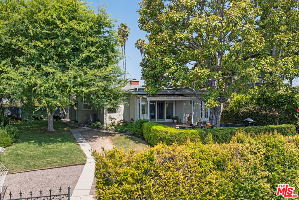 Nestled in Montecito Heights, this 1937 bungalow is your hillside hideaway with gorgeous views and an expansive yard. The spacious interior is filled with sunshine and period charm, featuring wood flooring, built-in cabinetry, and distinctive corner windows. Sliding glass doors lead to a covered patio and deck, a picturesque setting for outdoor dining and taking in the vistas. The updated galley kitchen is bright and cheerful, with ample storage and direct access to the yard. Two bedrooms include one with French doors to the patio, an easy guest room or home office. The flat backyard feels like a private retreat, with room to relax, gather, and enjoy the stunning scenery. Amenities include central air, laundry, and two-car garage. The serene location is close to Debs Park and local favorites Highly Likely, Villa's Tacos, Fresco Market, and more.