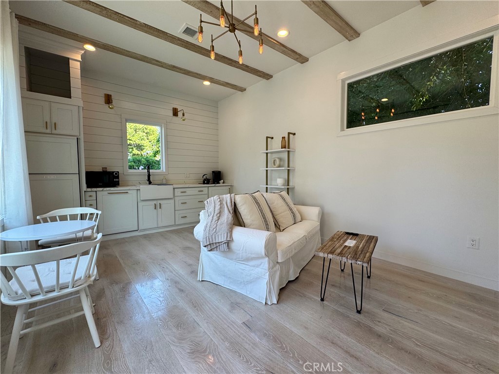 WELCOME TO YOUR NEW DREAM HOME—an exceptional, newer-construction stand-alone ADU that offers both privacy and style. This thoughtfully designed unit features its own private entrance and a beautifully landscaped yard with low-maintenance, western style drought-tolerant plants, perfect for relaxing or entertaining. Step inside to an open, airy floor plan filled with natural light, creating a warm and inviting atmosphere. The modern kitchen is outfitted with sleek quartz countertops, premium light fixtures, and high-efficiency appliances. The bedroom is spacious and bright, accessed through charming barn-style doors and includes ample closet space. The spa-inspired bathroom showcases a walk-in shower with high-end tile finishes, an oversized vanity, and a luxurious mirror area. Don’t miss your chance to call this unique home yours—schedule a viewing today before it’s gone!