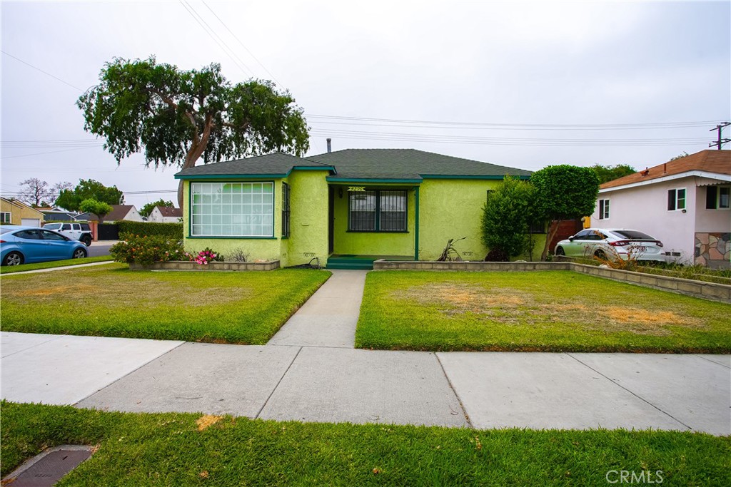Welcome to this warm and inviting 3-bedroom, 2-bath home in the heart of Lynwood. Built in 1946, this home has a lot of original character and space to make it your own.
The kitchen has a cozy breakfast nook, plenty of cabinet space, a built-in China cabinet, marble-style countertops and backsplash, a dishwasher, stove, and a separate double oven. A pass-through window connects to the spacious family room, making it easy to chat with guests while cooking. Just off the kitchen, there’s a hallway with pantry space, laundry hookups, and access to the second bathroom.
The living room features built-in shelves, a ceiling fan, blinds, and a wall heater. All three bedrooms have ceiling fans, and the primary bedroom includes double closets. The second bathroom has a standing shower for added convenience.
You’ll love the large family room with wood paneling and a rock-style fireplace, perfect for relaxing or entertaining. It has three separate exits: one to the garage, one to the backyard, and one side entrance with a sliding glass door. There’s also a dining area with room to gather for meals.
The backyard is private and fully enclosed with a brick wall and a well-kept lawn, great for family, friends, pets, or just entertainment. Security bars and doors are installed throughout the home for extra peace of mind.