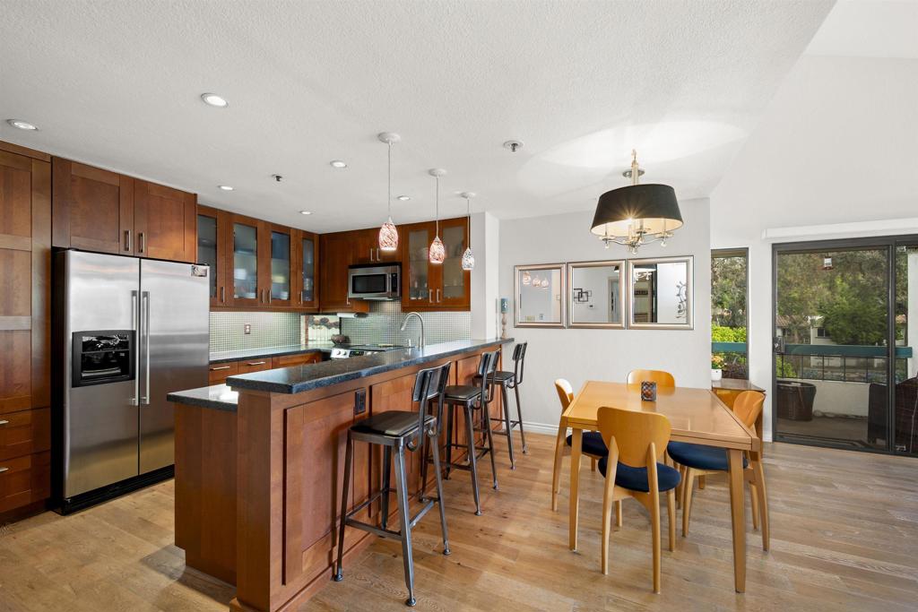 *Hidden Gem in the Heart of Tierrasanta!* Location, luxury, and lifestyle blend effortlessly in this beautiful top-floor corner unit, perfectly situated in Tierrasanta, San Diego’s Hidden Gem. This two-bedroom, two-bath condo has no shared walls, providing a peaceful and private retreat surrounded by lush greenery. The complex also has scenic views of the golf course. Step inside to discover vaulted ceilings, abundant natural light, and an open-concept living space accented by a cozy fireplace and a private balcony. The gourmet kitchen is designed to impress with rich cherry wood custom cabinetry, granite countertops, stainless steel appliances, a deep farmhouse sink, and elegant pendant lighting. The spacious primary suite boasts vaulted ceilings, a walk-in closet, and an extra mirrored closet, while both bedrooms have custom closets for optimal organization. Each bathroom has refined finishes, including sleek vanities and designer lighting. Additional amenities include in-unit laundry hookups and easy access to the elevator. Enjoy ample storage options, such as a private storage room off the balcony, extra storage in the second bedroom, and a dedicated storage locker next to the unit on the same floor. The home comes with one assigned parking space, plenty of guest and street parking, and the possibility to rent an additional assigned space through the HOA. Experience resort-style living with amenities like a sparkling pool, spa, and BBQ overlooking the golf course, tennis and pickleball courts, and a relaxing sauna. All of this is just moments from shopping, dining, top-rated schools, and major freeways, yet nestled in a peaceful, park-like community. It’s a truly unique residence in one of San Diego’s most desirable neighborhoods. Come see for yourself why Tierrasanta is the Hidden Gem that locals never want to leave.