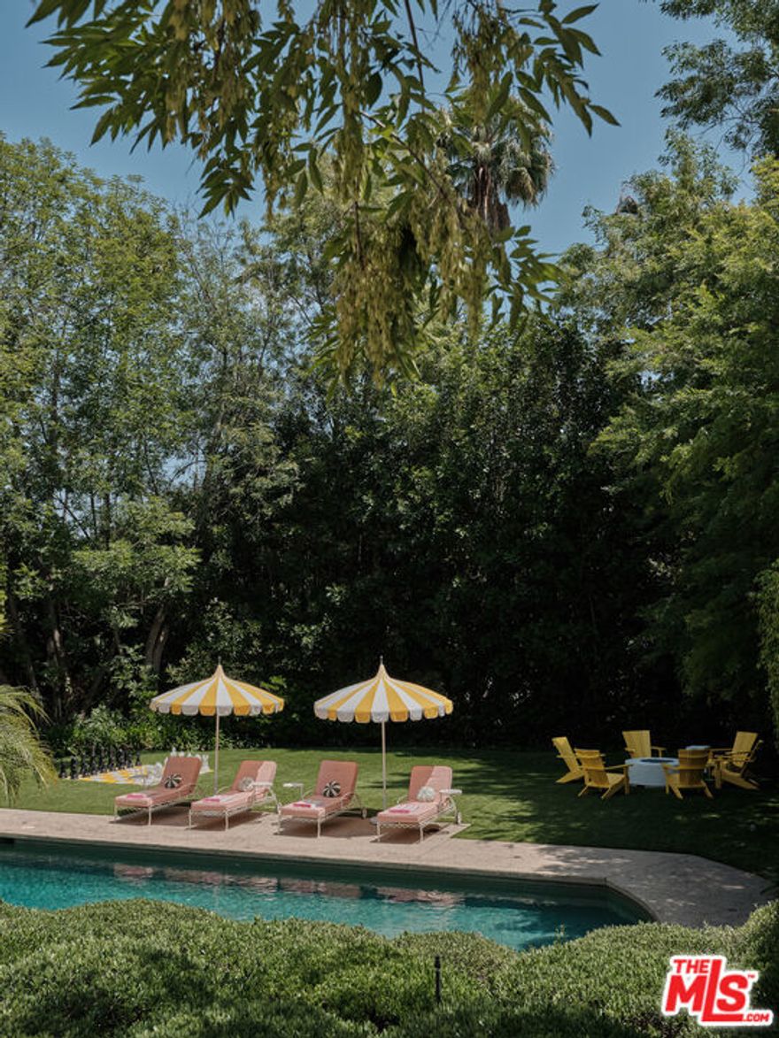 Beverly Hills Tennis Estate property unlike anything you've seen, hidden behind walls, gates & mature trees on over an acre of perfectly manicured park-like grounds in the prime foothills of Beverly Hills. Hosting a rich & elite Hollywood pedigree, up a long driveway on a knoll basking in the sun, sits this entirely reimagined home, colorfully curated by designer Angie Socas Coppel. Each room with its own joyful, lively and inspiring theme with an open floor plan with multiple spaces for entertaining.  The main floor features large living spaces, a renovated chef's kitchen with family room, staff quarters and office opening to an outdoor lounge, with Dining and Living rooms opening to the pool and grounds.  The 2nd-story consists of three generous bedrooms plus a full primary suite with separate office, lounge, dual bathrooms, dual walk-in closets & French doors that open to a private terrace overlooking the stunning grounds. The sprawling grounds hold a guest house, fully equipped gym, a large pool with separate spa, sauna and a serene, private & sunken championship tennis court. The motor court has parking for up to 25 cars and the property is dialed in with a smart house system, full cameras & security complete with hotel like amenities throughout. A prime compound in one of the world's most desirable locations.