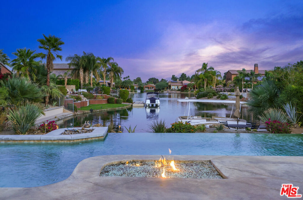 Celebrate holidays in Luxury on the Lake in exclusive gated community of Santo Tomas in Rancho Mirage. This lakefront private resort luxury home offers unobstructed lake and mountain Views. The home is recently upgraded with no detail overlooked. A new kitchen with quartz countertops, a farmhouse sink, stainless steel gas cooktop, and a large island, plus a breakfast/living area all overlooking the Lake & backyard. All bedrooms have new wall mounted flatscreen TV's, new porcelain tile wood floors, new furniture and LR with gas fireplace. Lakefront entertainment area with a dining area, gas firepit with built-in seating, and a cantilevered concrete dock to launch your paddleboard, canoe, or kayak. A covered Lakeview porch to eat or relax as there is an island stainless steel barbeque next to a 3-hole putting green. Swim in a newer Pebble-Tec pool with a stacked stone waterfall spa and beach entry. Close to all great shopping, restaurants, Agua Caliente Casino, The River, and El Paseo.