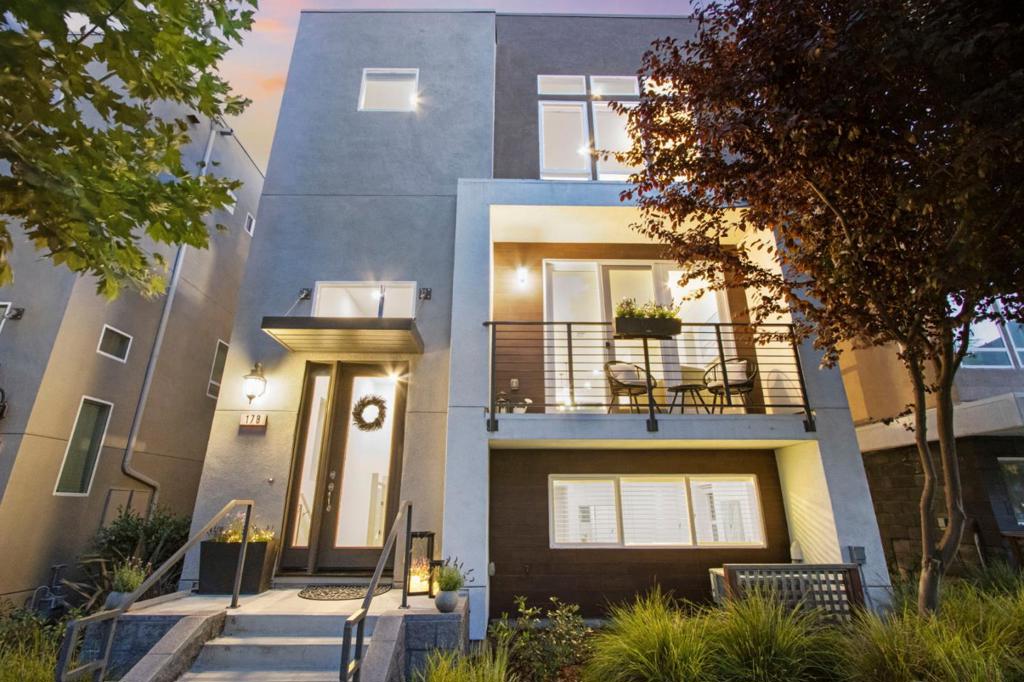 Welcome to this contemporary single-family residence nestled in the sought-after Communications Hill community. This beautifully designed home features soaring ceilings and expansive windows that flood the interior with natural light. Mature trees in the front yard provide both privacy and charm, while you're just steps away from a nearby park ideal for social gatherings and recreation. The ground level offers a primary suite, perfect for guests or family. On the second floor, enjoy an open-concept great room that includes a gourmet kitchen, dining area, spacious living room, powder room, and access to a covered balcony ideal for relaxing or entertaining.The top floor features a luxurious primary suite with a spa-like bathroom, dual vanities, and a generous walk-in closet. Two additional bedrooms, a full bath, and laundry room round out the top floor living space.Other features include laminate flooring throughout, water softener system, central AC, attached finished 2-car garage, extra storage and much more. Centrally located close to all major transportation routes, San Jose Airport, downtown San Jose, and great shopping/dining. Communications Hill community provides ample parks, a playground, BBQ areas, walking trails and much more!