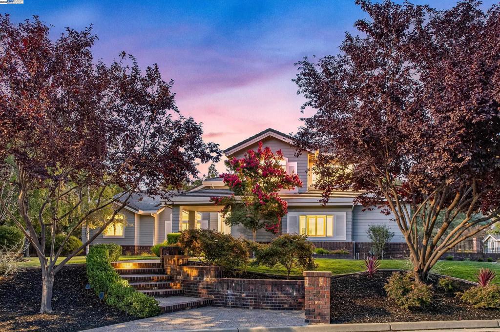 Nestled in the prestigious Kottinger Ranch community, this remarkable 6-bedroom, 5.5-bath estate offers 4,746 sq. ft. of refined living space on a sprawling serene half-acre parcel. With panoramic views of rolling hills and majestic oak trees, this home seamlessly blends luxury with nature. Step inside to soaring ceilings, walls of windows, and light-filled interiors that create an airy, welcoming ambiance. Designed for multigenerational living, the home features two primary suites—one on each level. The expansive downstairs suite is a true retreat, complete with a cozy fireplace, dual walk-in closets, a luxurious stone shower, heated floors, and French doors opening to a private backyard sanctuary. The chef’s kitchen boasts sleek quartz countertops, crisp white cabinetry, and effortless flow to the dining and living spaces. Entertain with ease at the wine bar, in the family room framed by sweeping views, or outdoors—where a sparkling pool, spa, expansive patios, deck, lush lawn, and charming garden await. Additional features include a first-floor guest suite, dedicated office, two laundry rooms and access to scenic trails, community pool, tennis courts, and top-rated Pleasanton schools. Minutes to wineries and vibrant downtown Pleasanton. Side access w/room for ADU, bocce etc