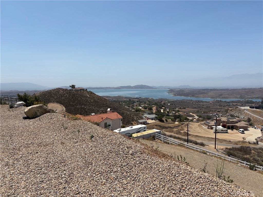 Breathtaking view 2.5 acres building lot. Panoramic view of Lake Mathews, mountains and valleys. You can see for miles. The view is approximately 300 degrees of unobstructed view. This fabulous view lot is ahead of many of the lots for sale, because of the work done by seller. Permits are granted, filled and signed off. This makes months of waiting and work done by seller that would be saved over unimproved lots. Definitely something to consider when planning to build. The lot grading plan and house pad have finalized approval by Riverside County. Water is connected with water meter. Electricity is ready to pull, next to property. The retaining wall is permitted. There is fire truck knockout. At the top of the lot is a metal carport. The lot is completely fenced with wire fencing and white vinyl fencing at front gate entrance. All the hard work is done! This lot is ready to build!