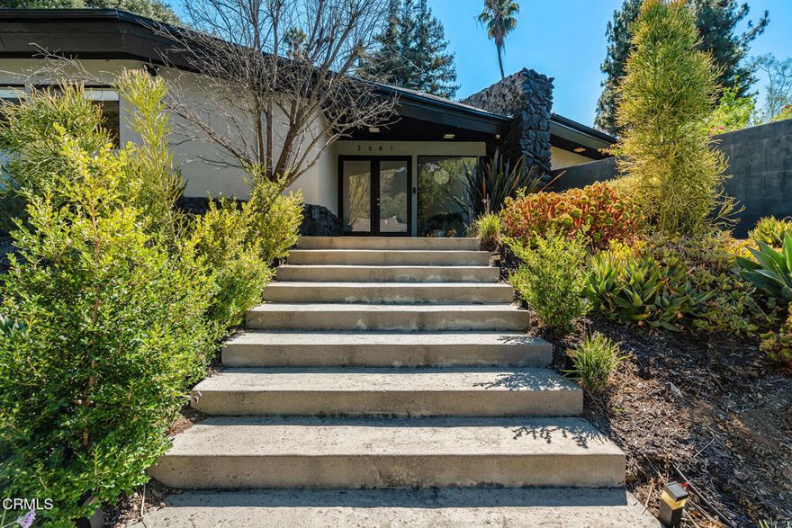 Spanning nearly 3,900 square feet, this expansive single-story residence blends timeless design with sophisticated upgrades. Four spacious bedrooms and four stylish baths anchor a thoughtful floor plan designed for today's lifestyle, while soaring 9-foot exposed beam ceilings, two fireplaces, and walls of glass invite warmth and light throughout.The sleek, custom kitchen and modernized bathrooms pair function with style, complemented by rich solid hardwood floors. Multiple private outdoor areas--including a sparkling pool surrounded by mature fruit trees--offer the perfect backdrop for entertaining or quiet retreat. A versatile bonus room off the primary suite makes an ideal gym, studio, or lounge.Set within the highly sought-after Royal Woods neighborhood, this property offers both privacy and convenience, with easy access to Ventura Blvd, Sepulveda, the 405, and the 101--placing shops, dining, and studios just minutes away.This home is a rare find where elegance, comfort, and location converge. Come experience the best of Sherman Oaks living.