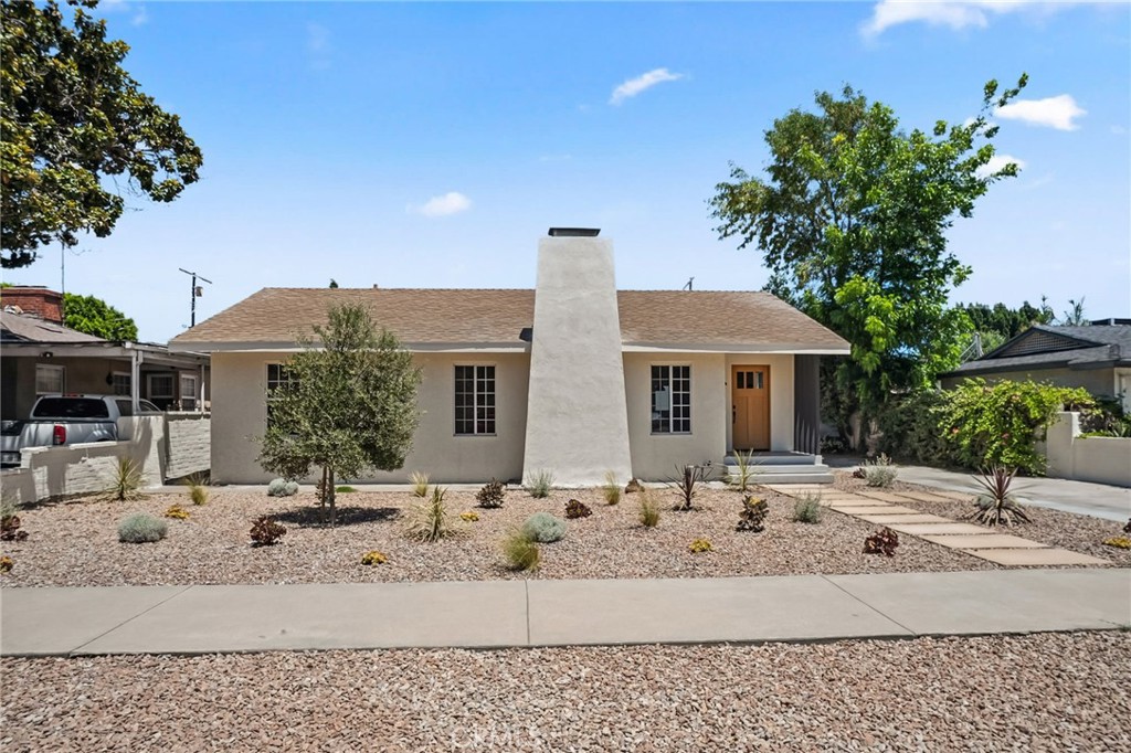 Charming and newly remodeled home for lease in Valley Village! Drought tolerant landscaping and inviting pathways lead to this 3 Bedroom, 3 Bathroom home with over 1,900+ square feet of living space. Light and bright home with an open floor plan features a sun filled living room with sleek fireplace, high ceilings, recessed lighting, wide planked vinyl wood floors and overlooks the spacious kitchen. Newly remodeled kitchen features Calacatta quartz countertops & backsplash, stainless steel Samsung fridge & dishwasher, Thor oven range with built-in pot filler, Kraus stainless steel sink, custom cabinets with spice racks, trash can pull-out, soft close hinges, and a large center island with built in breakfast bar & elegant pendant lights. Adjacent to the kitchen is a formal dining room and/or den allowing for a versatile floor plan. Primary bedroom is spilt level with laundry closet, built-in vanity area, sunken bedroom with custom built walk-in closet and sliding glass door overlooking the patio area. Stunning primary bathroom with dual sinks, illuminated mirrors, porcelain floors, massive walk-in shower stall with a ceiling mounted showerhead and additional storage closet. Second bedroom is ensuite and features high beamed ceiling, ceiling fan, walk-in closet, and its own bathroom with Calacatta quartz countertop, custom flooring, and shower tub. Hallway/guest bathroom is also completely remodeled with equally beautiful finishes and is adjacent to ample sized third bedroom with frosted glass closet doors and overlooks the front yard. Additional features include brand new HVAC system, dual paned windows, and recessed lights throughout. Rental Property Owner is in the process of building an ADU in the backyard so the property will eventually be shared, but will be gated off for privacy. Wonderful location with easy freeway access, close to shops/restaurants, great school systems (i.e. Colfax Elementary, Walter Reed, etc.), Valley Village Park, and much more.