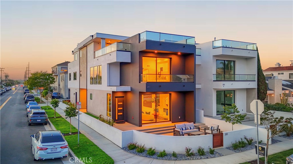 After overwhelming demand for its corner-lot counterpart at 201 Indianapolis, the opportunity has arrived to own the equally striking 203 Indianapolis Ave, now fully completed and ready for its first owner. Nestled just steps from the sand, Pacific City, and Main Street, this brand-new modern coastal residence delivers architectural brilliance, refined functionality, and a turnkey luxury lifestyle in the heart of Huntington Beach.
Spanning three levels with a private elevator and an expansive rooftop deck, the home is designed for seamless indoor-outdoor living with walls of glass, Fleetwood-style doors, and multiple outdoor retreats capturing natural light and ocean breezes. The open-concept main floor showcases a chef’s kitchen with custom cabinetry, high-end appliances, and a statement island that flows effortlessly into the living and dining spaces.
The primary suite offers a spa-inspired bath, walk-in closet, and private balcony, while secondary bedrooms provide flexibility for guests, an office, or fitness space. Every detail—from custom finishes to thoughtful floor plan design—has been curated to elevate modern coastal living.
With its Certificate of Occupancy secured, 203 Indianapolis is move-in ready, offering the rare chance to own new construction luxury in Surf City. Whether entertaining on the rooftop deck, enjoying sunset strolls to the beach, or dining at world-class restaurants just minutes away, this home is the perfect blend of style, comfort, and location.
Don’t miss your chance to make 203 Indianapolis your own—the sequel to Huntington Beach’s most talked-about new build.
Interior images depict 201 Indianapolis, a staged corner lot model. 203 Indianapolis is the same new construction design but is currently unfurnished.”
