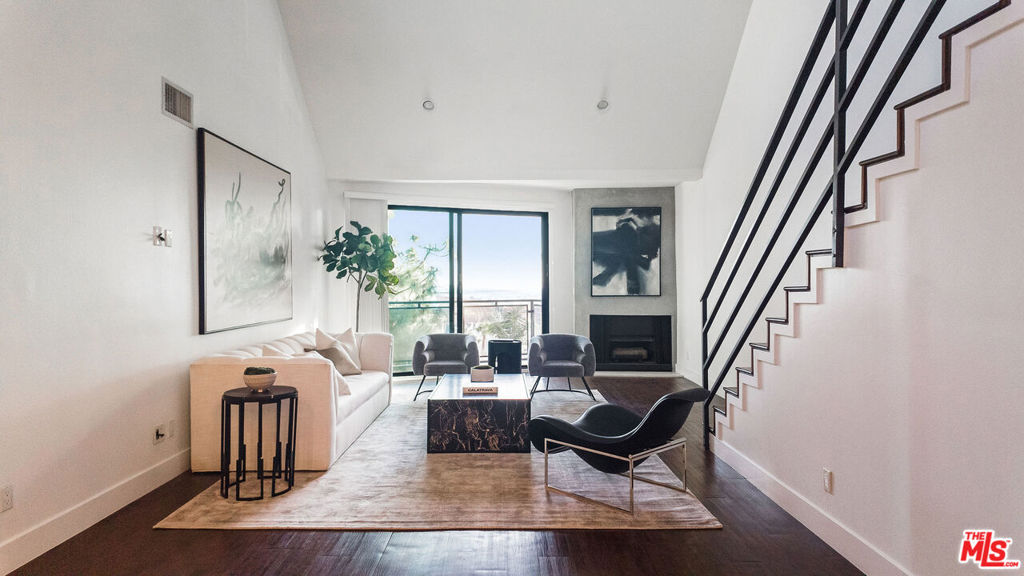 Absolutely massive 2-bedroom, 2.5-bathroom Loft unit featuring an incredibly private rooftop oasis. This unit boasts a fully updated kitchen with luxurious walnut cabinets, high-end stainless steel appliances, and exquisite Silestone countertops. The expansive bathrooms also showcase opulent walnut vanities with double sinks for ultimate convenience. The primary bedroom dazzles with its exceptionally spacious walk-in closet, complemented by two additional closets along the wall for ample storage. Additional remarkable amenities include a private rooftop retreat and an impressively large balcony that spans the entire front of the unit. Recessed lighting adds a touch of modern elegance, while every room is pre-wired for your flat screen TV and internet needs. The in-unit washer and dryer provide ultimate convenience, and the generously sized kitchen island comfortably seats up to 6 guests. The living room is adorned with a contemporary fireplace, and the 8-foot high Fleetwood sliding doors offer breathtaking southern exposure and panoramic city lights views. Secure parking and an on-site gym complete the offerings of this exceptional building. Located just one block north of Sunset Plaza, relish in the tranquility of this quiet street while still being within short distance of everything your heart desires!