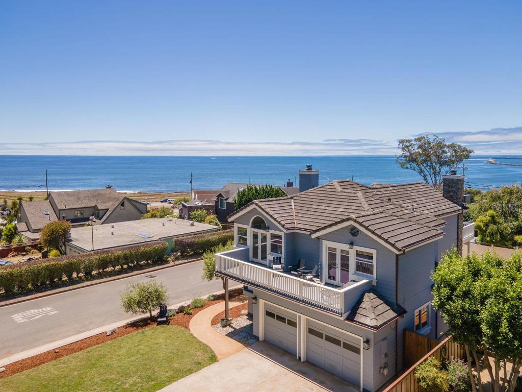 Welcome to your Coastal Dream Home! This beautifully appointed 3-bedroom, 2.5-bathroom residence offers the perfect blend of coastal charm and spectacular ocean views! Step inside to discover a light-filled interior featuring hardwood floors, a cozy fireplace in the family room, and a gourmet kitchen with quartz countertops, stainless steel appliances, and a 6-burner Wolf gas range, a chefs delight! The primary suite is a true retreat, complete with its own fireplace, spa-like bathroom, and deck with breathtaking ocean views. Enjoy panoramic vistas of the Pacific from the kitchen, upstairs bedrooms, and multiple decks, perfect for relaxing or entertaining. The spacious garage offers ample storage for all your coastal lifestyle gear. Located just a short stroll from Surfers Beach, the Coastal Trail, and Quarry Park, this home is a gateway to some of the best outdoor recreation on the Coast. With easy access to Highway 1, you're just a short commute from San Francisco, Silicon Valley, the San Mateo Peninsula, and SFO. Whether you're seeking a full-time residence or a weekend escape, this is a true Coastal Gem.