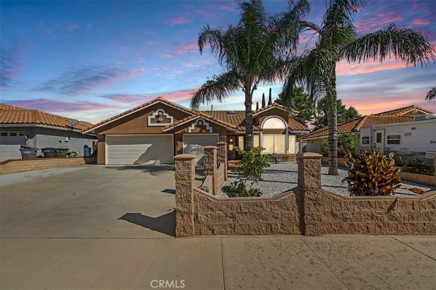 Welcome to 29060 Palmview St., a beautifully upgraded single-story home offering 4 bedrooms, 2 bathrooms, 1,924 sq. ft. of living space and a 7,405 sq. ft. lot with RV/boat parking and a 3-car garage. The exterior features low-maintenance landscaping with white rock, mature palm trees, stackable cinderblock planters, vinyl gates, Spanish tile roof, and rain gutters routed underground. Inside, natural light fills the home through dual-pane windows, sliders, and a skylight in the living room. Enjoy large tile flooring, recessed lighting, updated outlets and switches, and a cozy gas brick fireplace. The remodeled kitchen showcases shaker-style cabinets, quartz countertops, sleek glass backsplash, LED undercabinet lighting, and black stainless steel Samsung appliances—all included. Spacious bedrooms feature upgraded carpet and ceiling fans. Both bathrooms have been remodeled with new vanities, tile, toilets, and showers. The primary suite offers vinyl flooring, his and her closets, private patio access, and a beautifully updated bathroom. Outdoor living includes two patios—one enclosed with tile and another with recessed lighting—plus new concrete hardscape, brickwork, upgraded drainage, and fruit trees including two lemon, sweet lime, blood orange, pomegranate, fig, peach, plum and some pepper plants! Conveniently located near schools, shopping, dining, and Lake Elsinore recreation. Don't miss this opportunity!