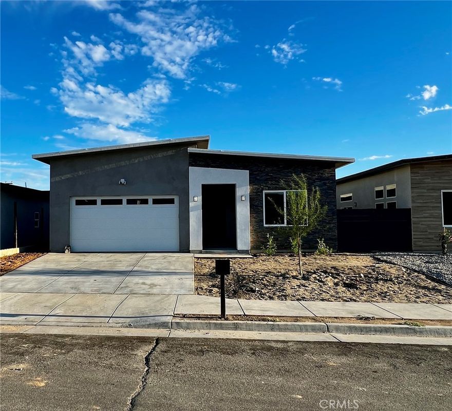 Here is a brand new 4-bedroom, 2-bath home that combines modern style with everyday comfort. Located in Desert Hot Springs near the Desert Hot Springs High School. This home features spacious rooms, high ceilings, and plenty of natural light. Want lower electric bills, this home comes with paid solar! Enjoy laminate wood floors in the main living areas, sleek tile bathrooms with glass shower doors, and a bright, modern kitchen with quartz counters, white cabinets, and lots of storage perfect for cooking and entertaining. The master suite has a large bathroom with a dual-sink vanity and all the modern touches. Best of all, there are no HOA fees. Sectioin 8 welcome.